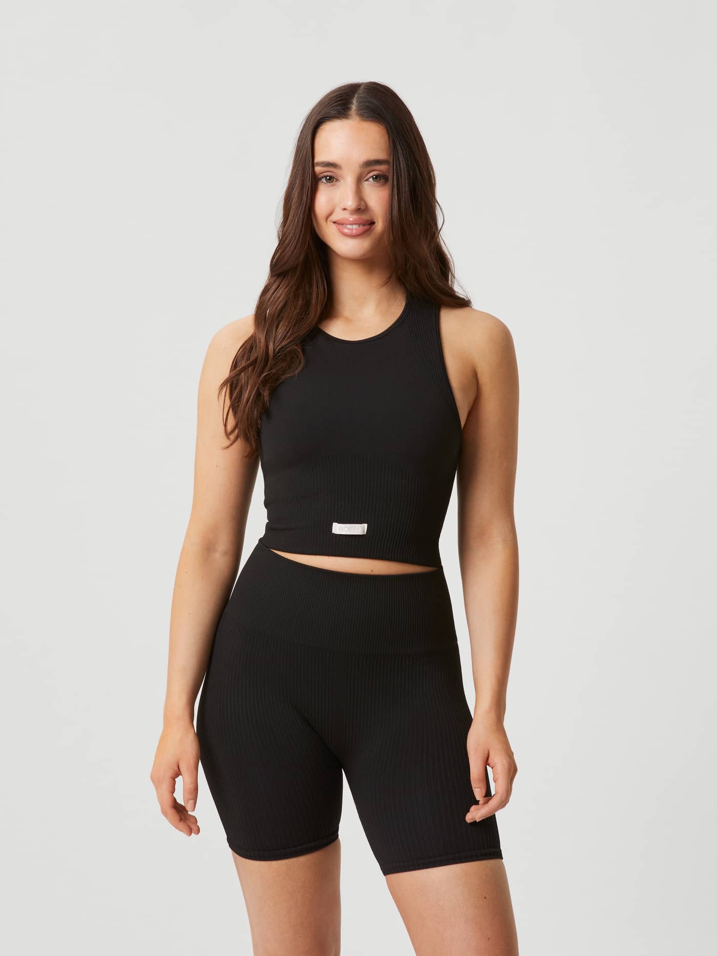 Front view of a model wearing the black Björn Borg Studio Seamless Bralette in a slim fit for mid-support training. - Image 4