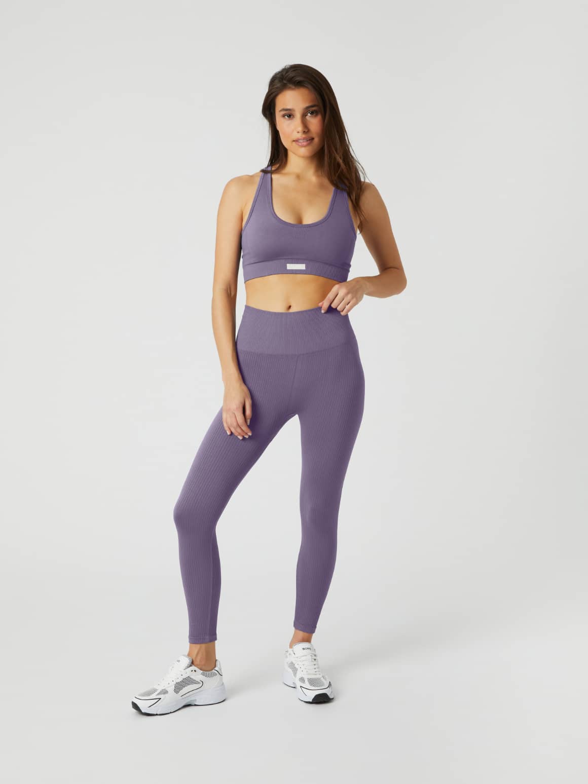Full-body front view of a woman wearing the Björn Borg Studio Low Seamless Bra in Purple Sage (Purple) for training. - Image 3