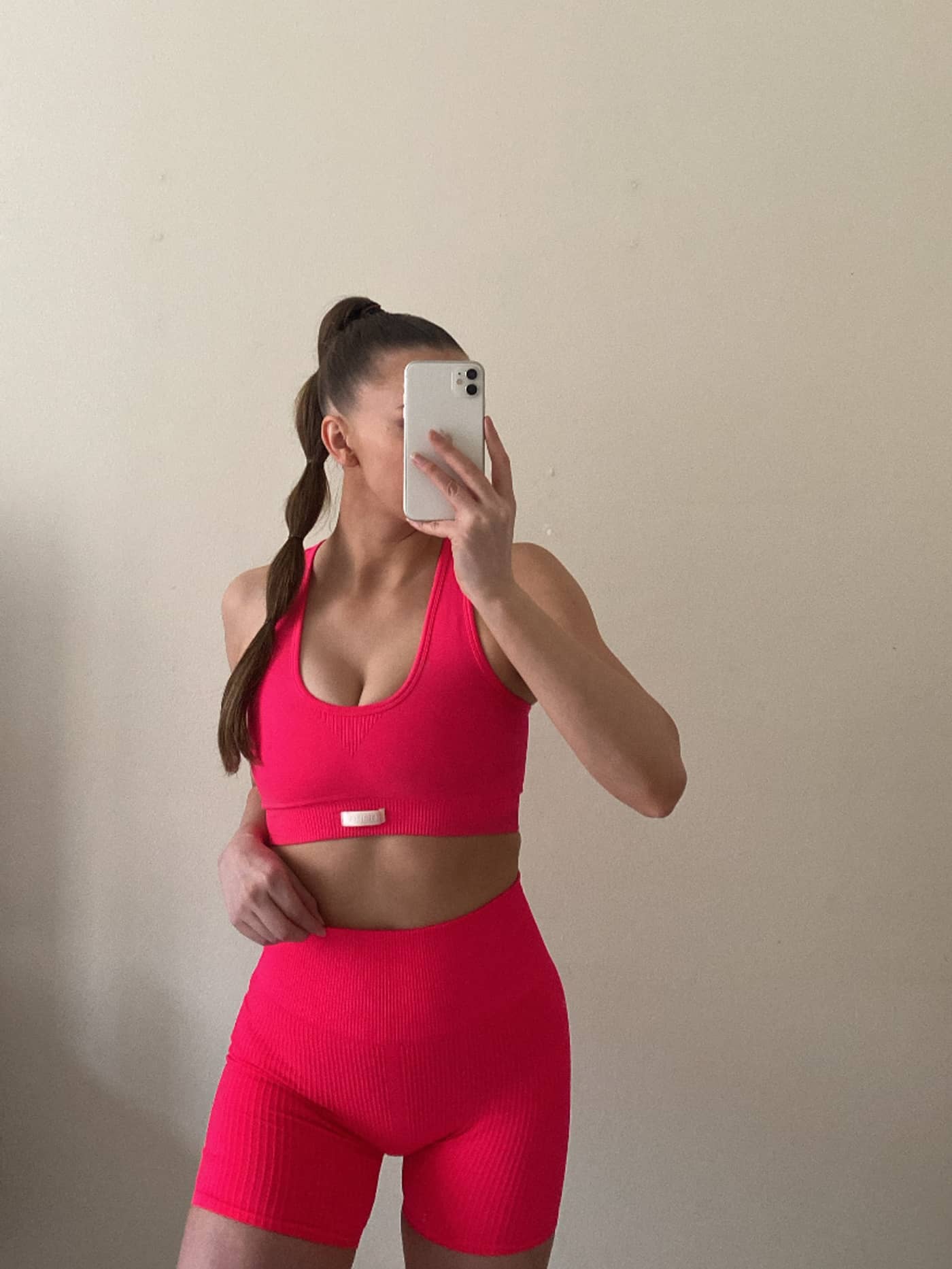 Front view of a woman in pink Björn Borg Studio Seamless Rib Shorts, featuring a high-waist seamless training fit. - Image 5