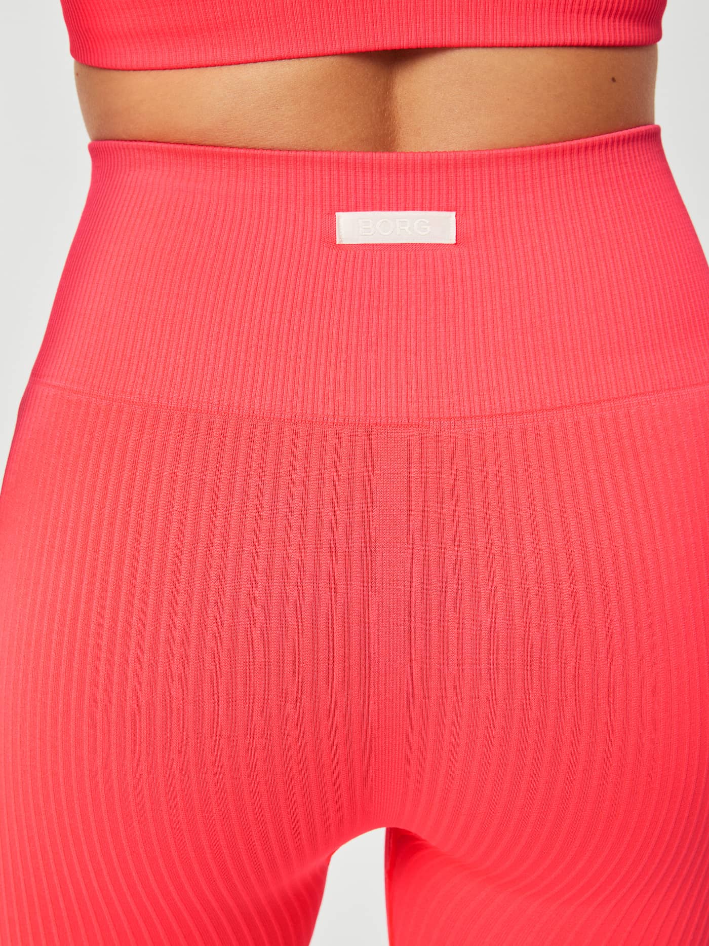 Back close-up of the Studio Seamless Rib Shorts in Diva Pink (Pink) for training, with a ribbed fit and white BORG logo. - Image 7