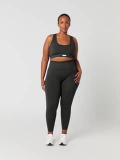 Full-body front view of a woman in the high-waisted Björn Borg Studio Seamless Rib Tights in Peat (Green) for training. - Image 5