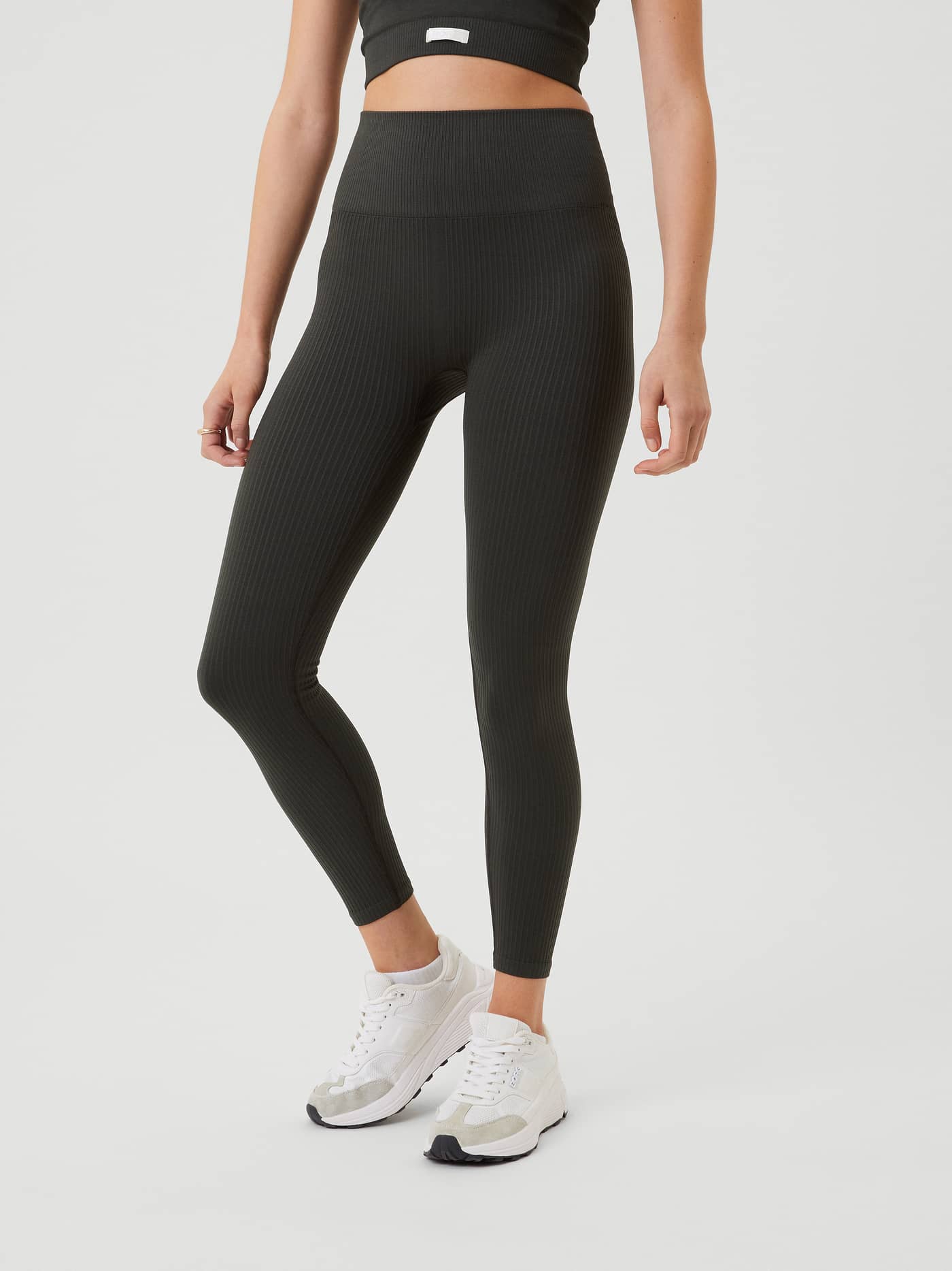 Front view of a model wearing the Björn Borg Studio Seamless Rib Tights in Peat, featuring a ribbed training fit. - Image 2