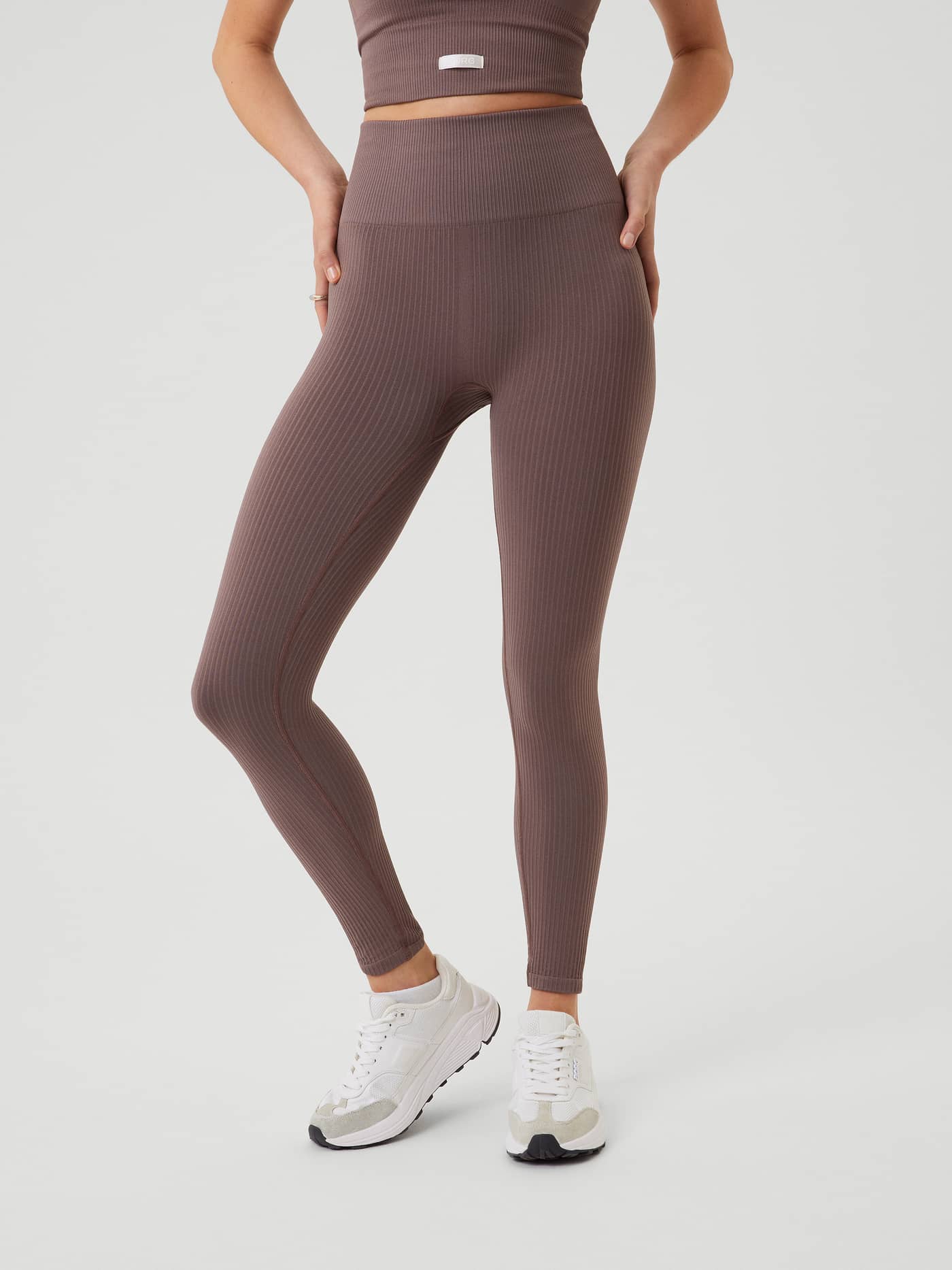 Front view of a model wearing the high-waisted Studio Seamless Rib Tights in Sparrow (Brown) for a seamless training fit. - Image 2
