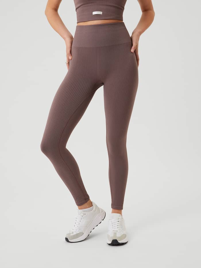 Front view of a model wearing the high-waisted Studio Seamless Rib Tights in Sparrow (Brown) for a seamless training fit. - Image 2