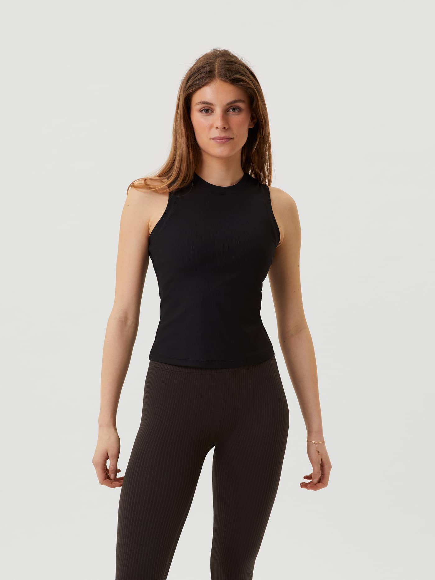 Front view of a model wearing the ribbed Björn Borg Studio Rib Tank in Black Beauty (Black), a slim-fit training top. - Image 1