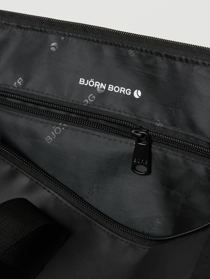 Interior view of the training Borg Duffle Tote 28L in Black Beauty (Black) with logo-patterned lining and white logo. - Image 4