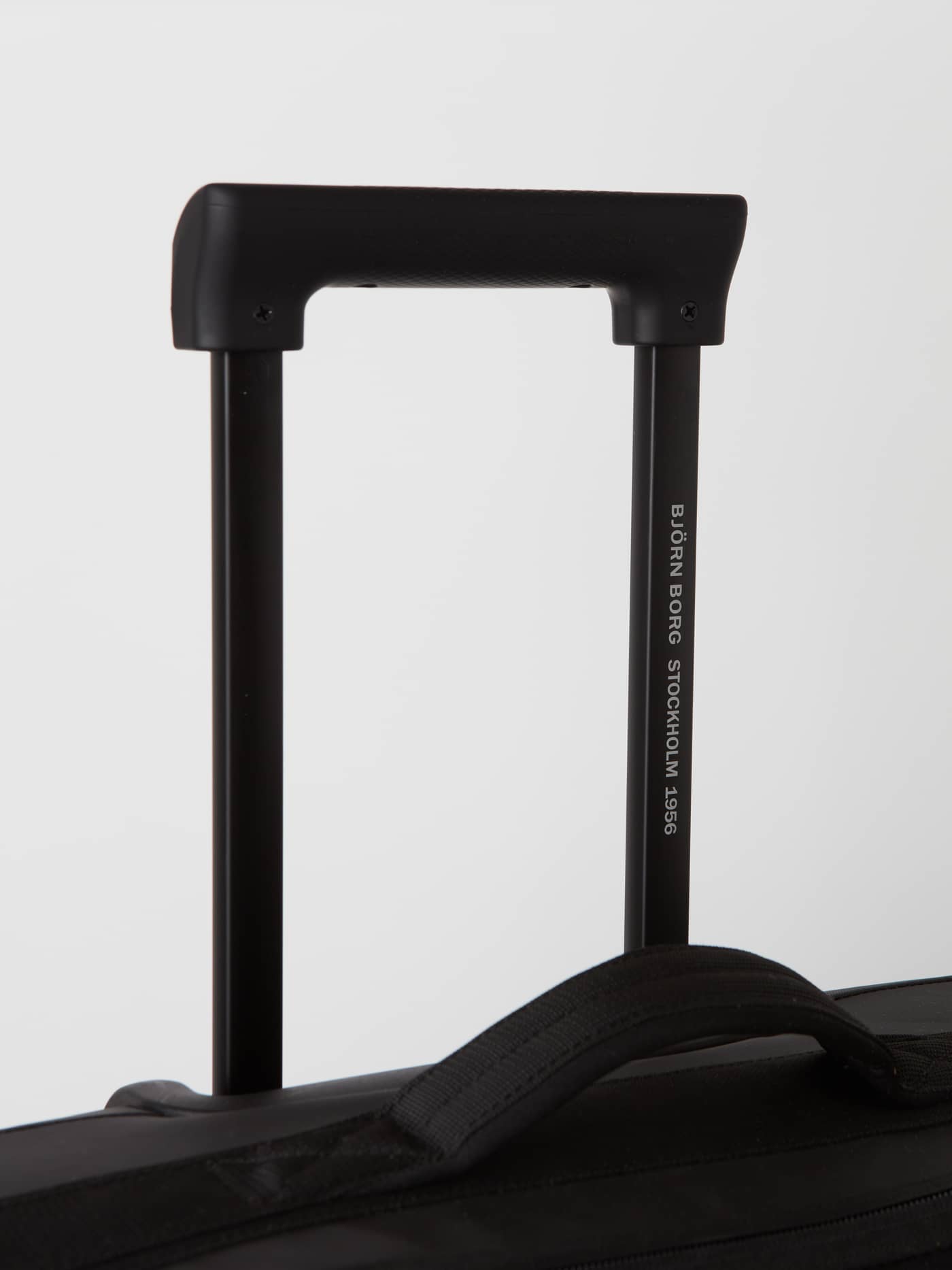Close-up of the telescoping handle on the Borg Travel Trolley S - 46L in Black Beauty (Black) with white logo text. - Image 11