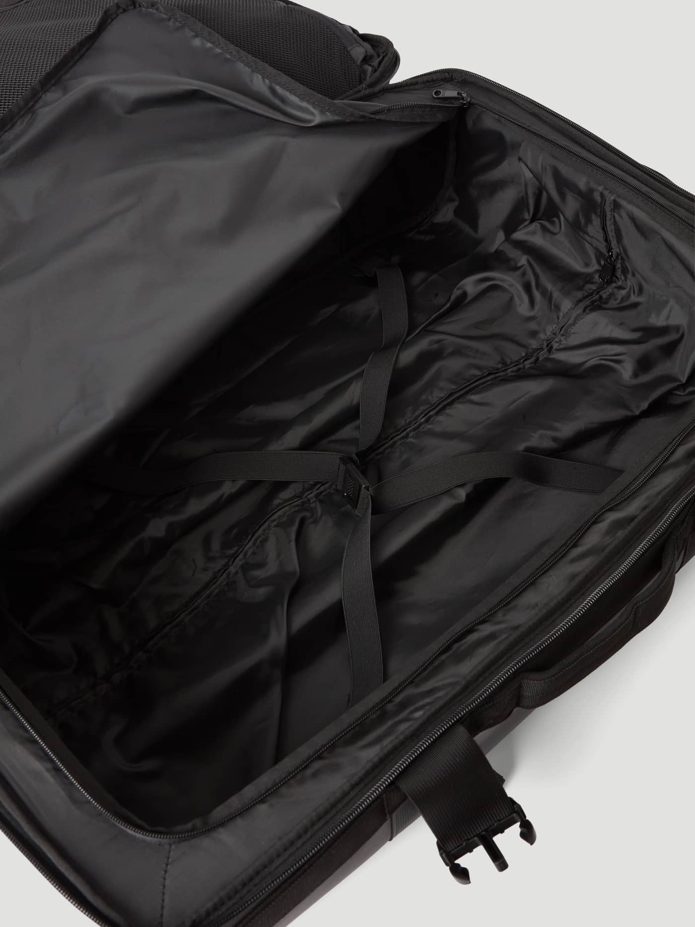 Interior view of the open Borg Travel Trolley S - 46L in Black Beauty (Black) featuring packing straps and lining. - Image 6