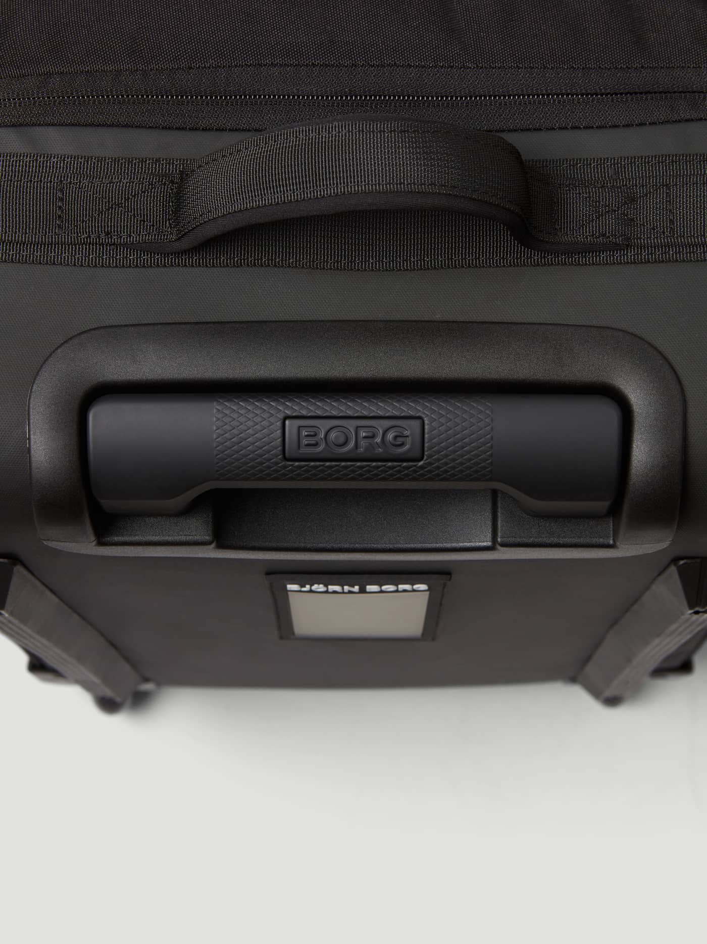 Detailed view of the handles and durable material on the Borg Travel Trolley S - 46L in Black Beauty (Black). - Image 5