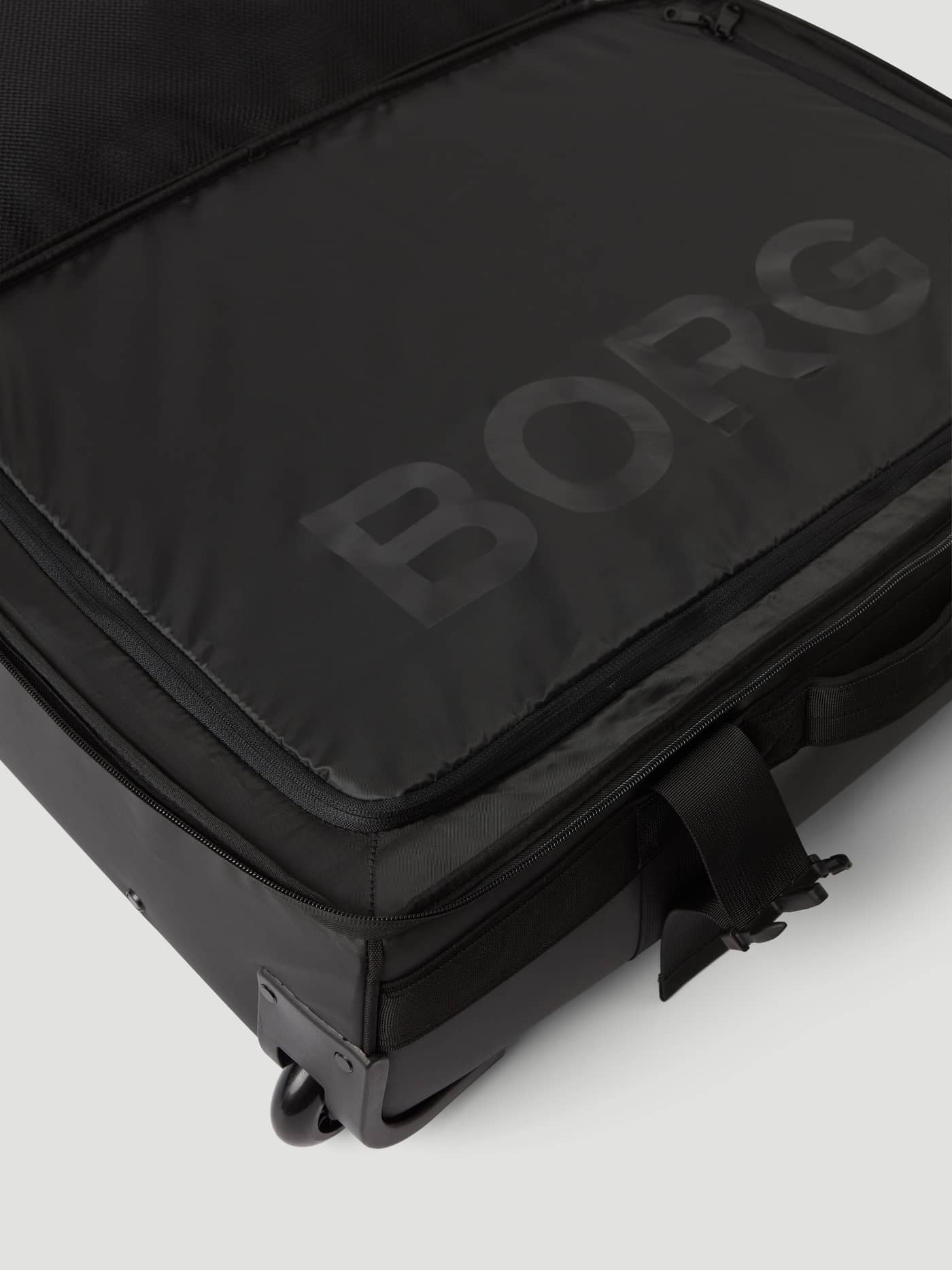 Detailed close-up of the Borg Travel Trolley S - 46L in Black Beauty (Black) featuring a tonal logo and durable wheels. - Image 8