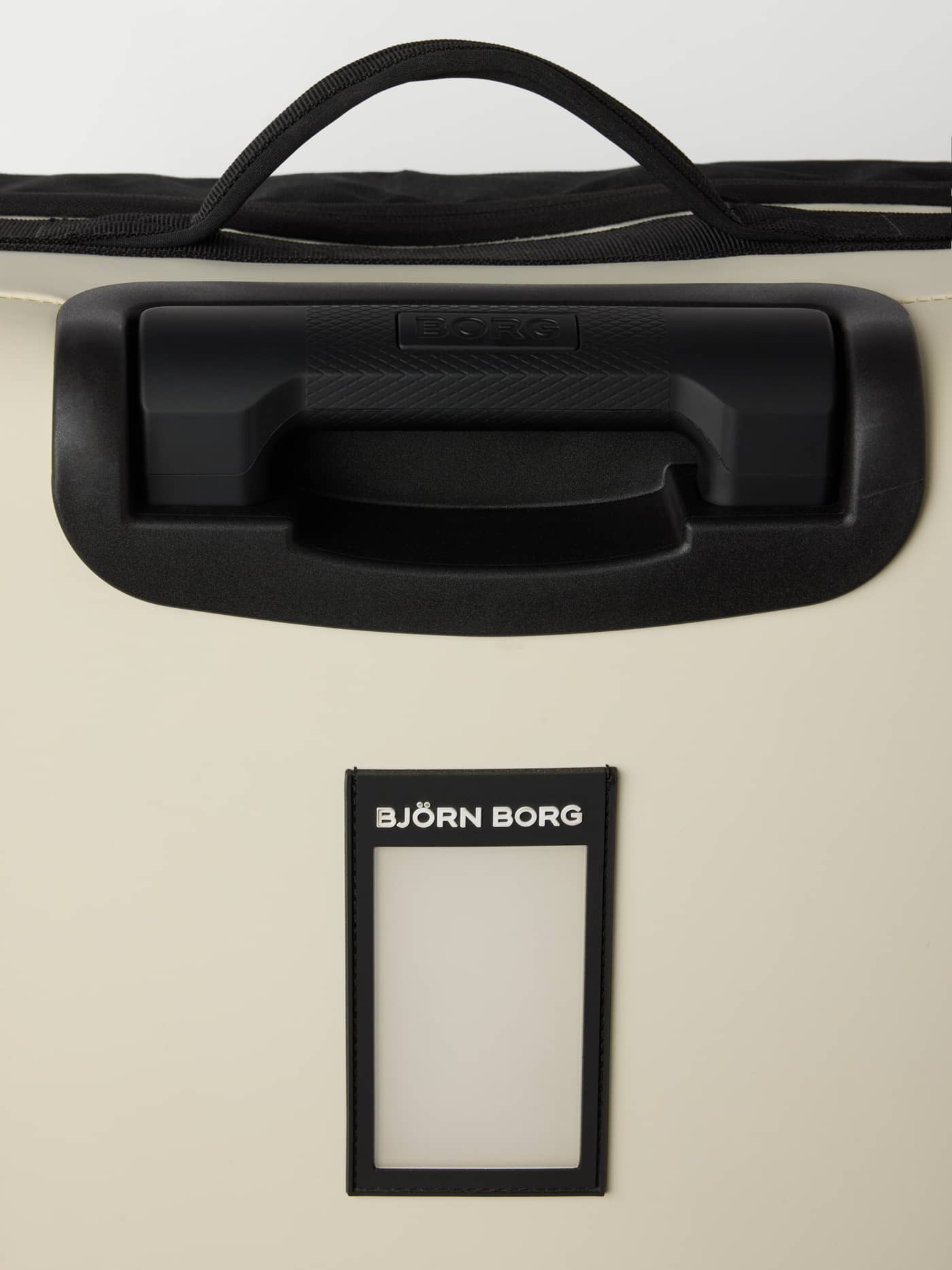 Close-up of the Bone White (White) Borg Travel Trolley L - 80L, featuring black handles and a white logo on the ID tag. - Image 6