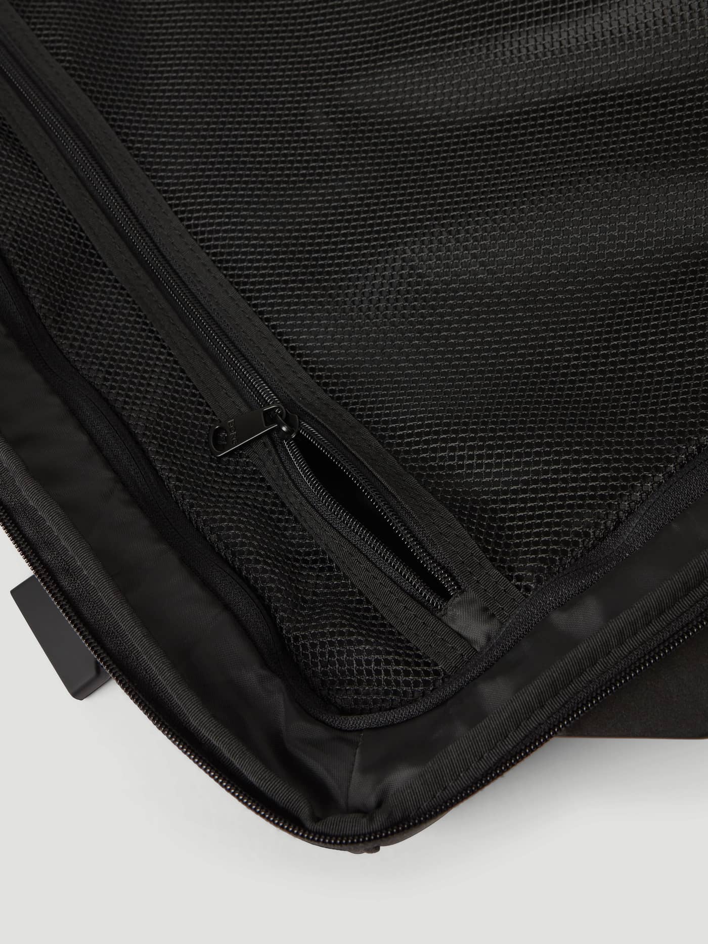 Interior close-up of the Borg Travel Trolley L - 80L in Black Beauty (Black) with a durable zippered mesh compartment. - Image 6