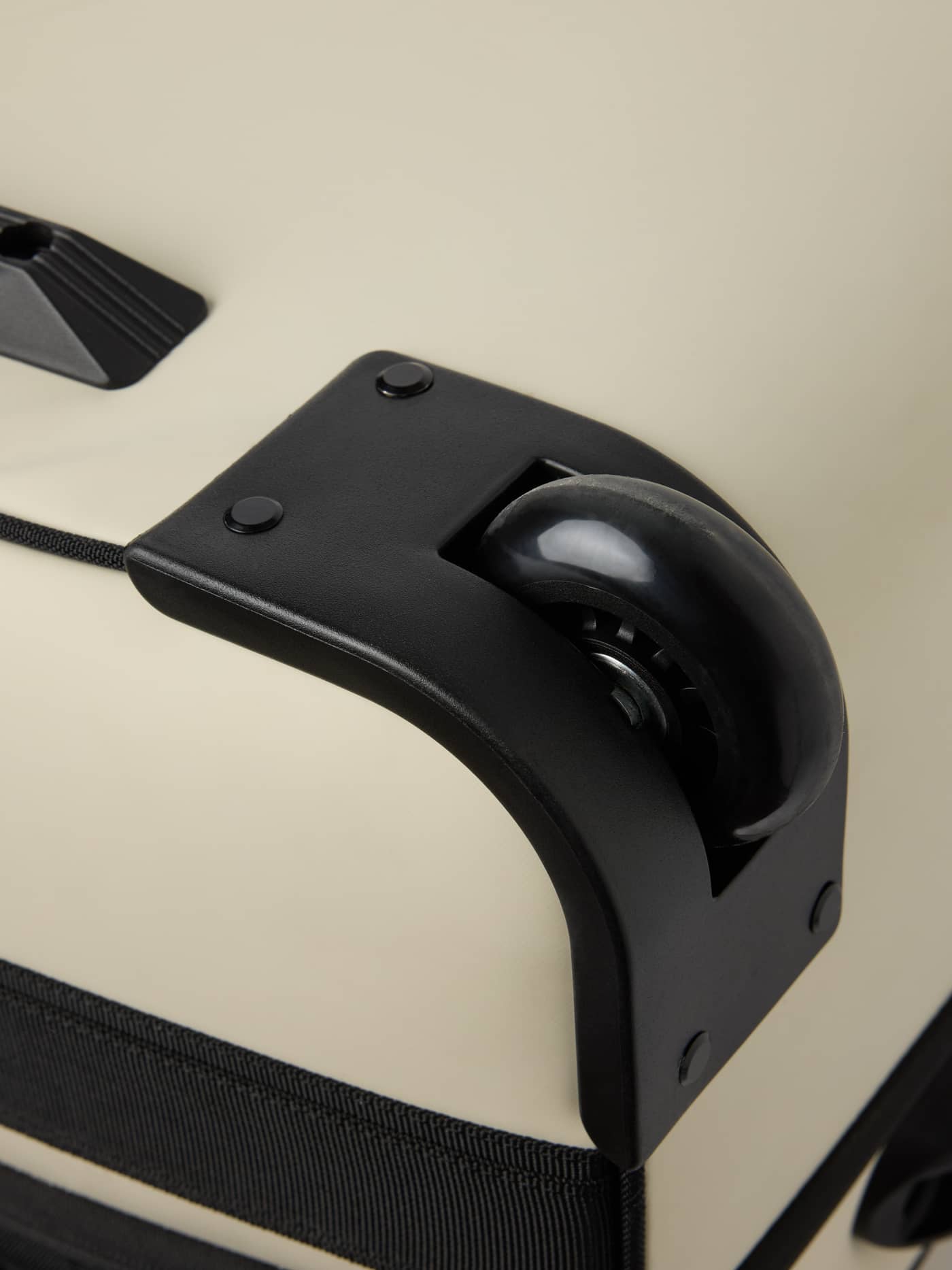 Detailed close-up of the stable wheel on the Borg Travel Trolley L - 80L in Bone White (White). - Image 7
