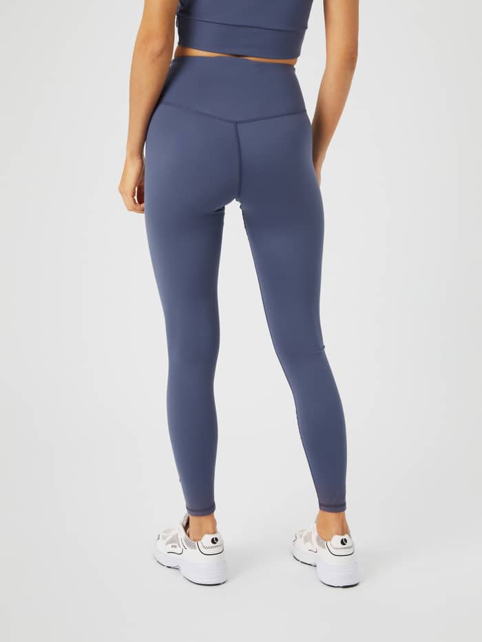 Back view of a model wearing the Björn Borg Studio Cross Tights in Nightshadow Blue (Blue) for a supportive training fit. - Image 3