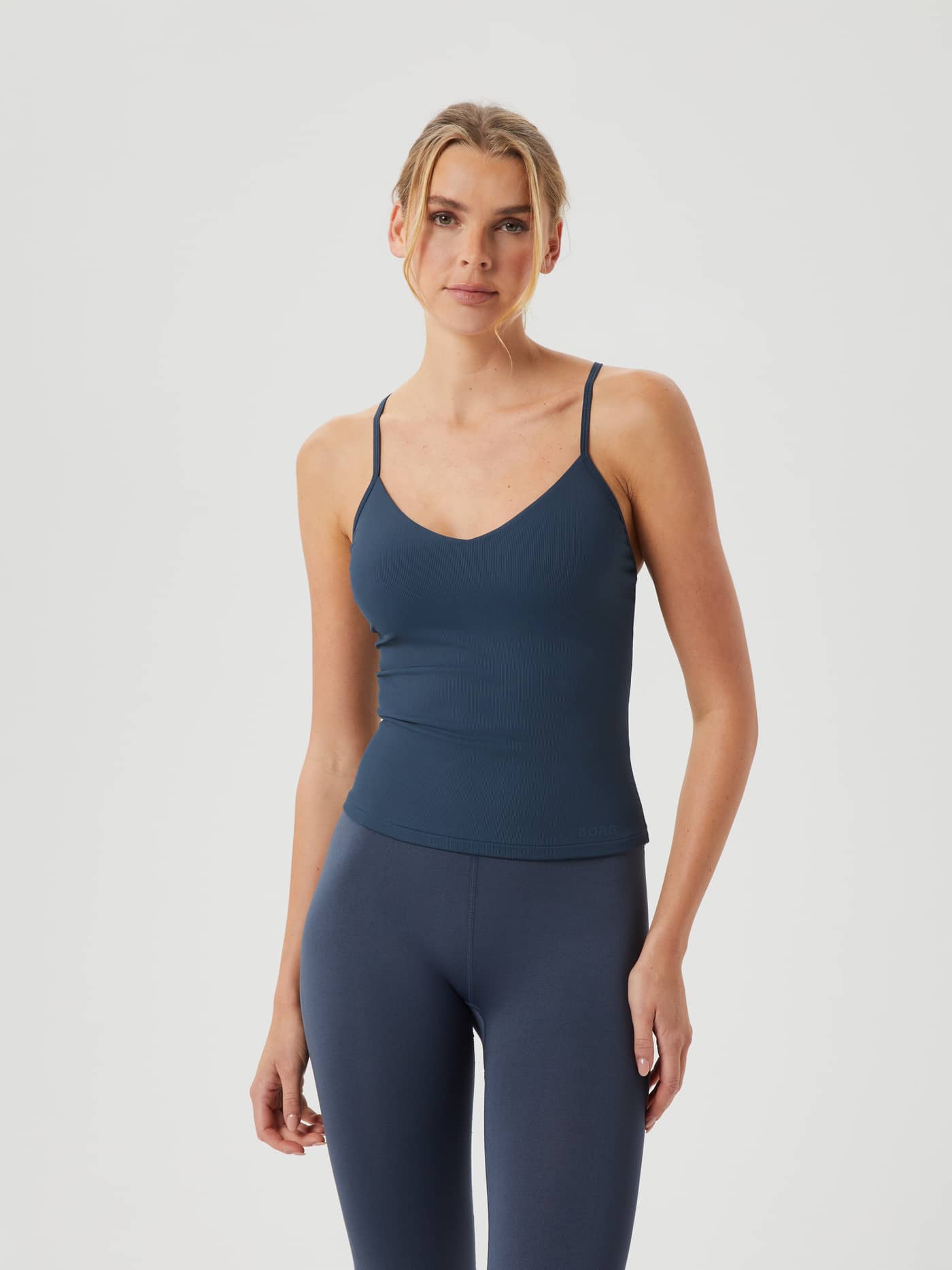 Front view of a model wearing the Studio Rib Strap Tank in Midnight Navy (Navy), a ribbed slim-fit training top. - Image 3