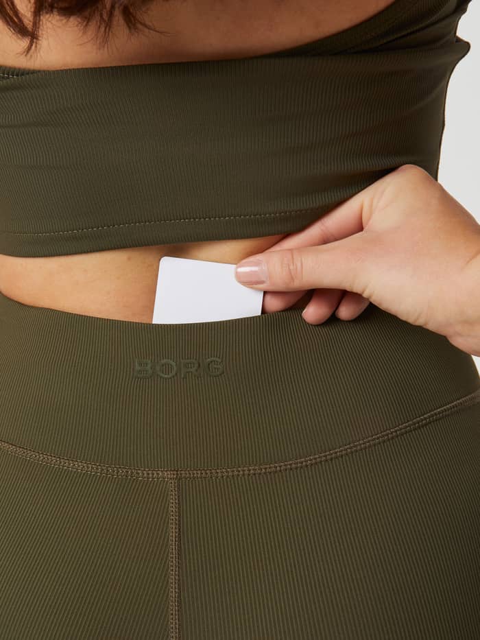 Hidden pocket and tonal Borg logo on the rib-knitted Studio Highwaist Rib Tights in Olive Night (Green) for training. - Image 4