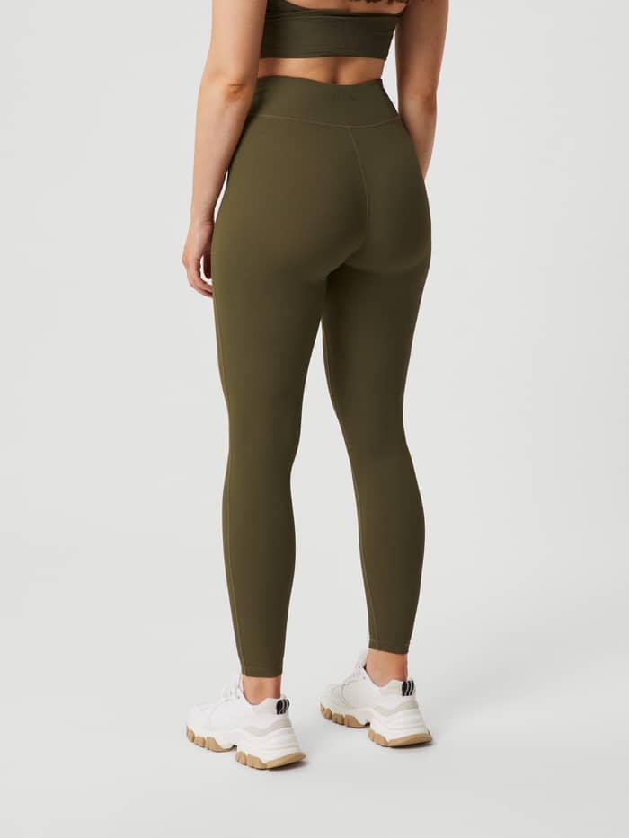 Back view of the Studio Highwaist Rib Tights in Olive Night (Green) featuring a tonal back logo and slim training fit. - Image 3