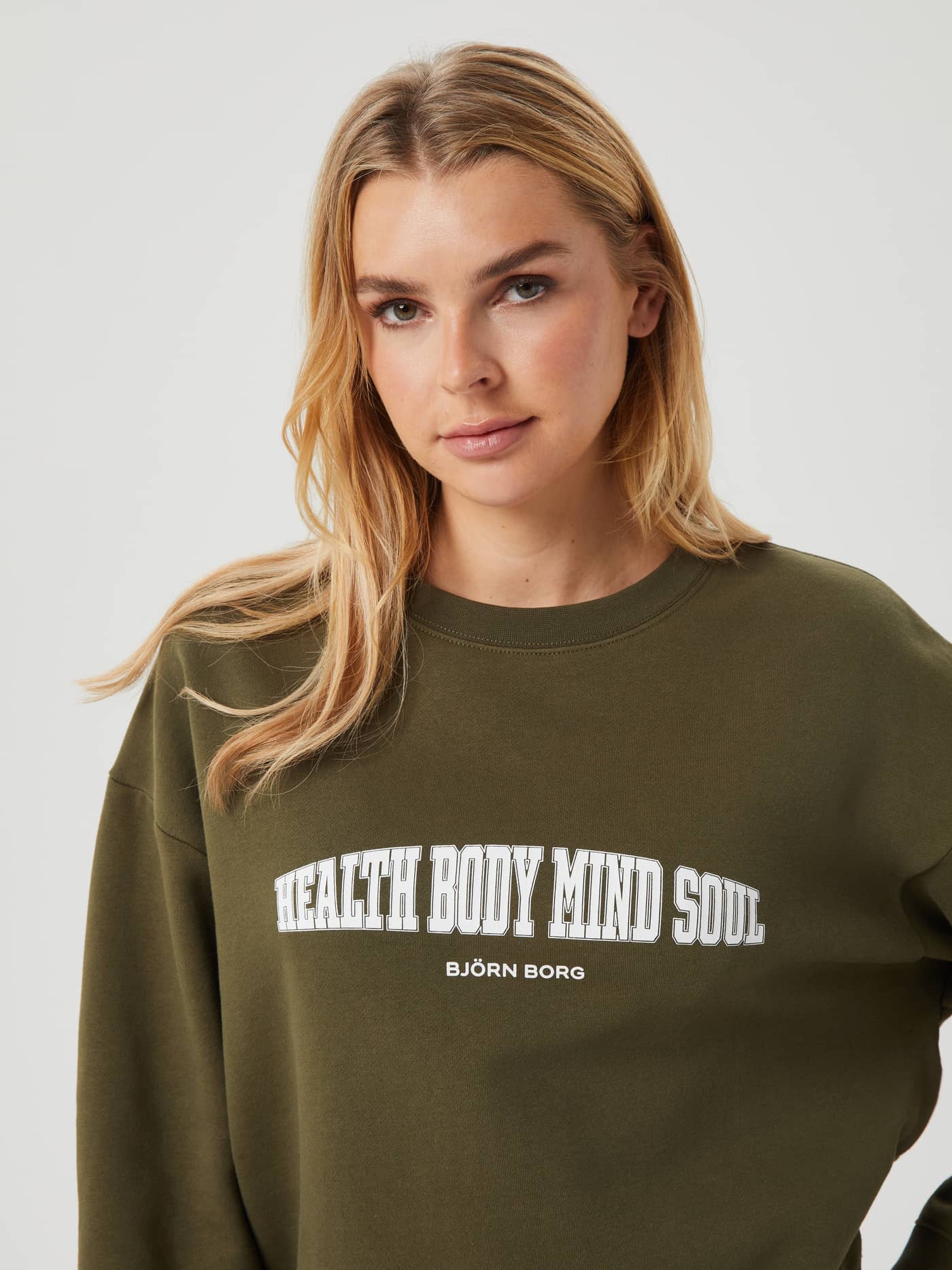 Close-up of the cotton-blend Björn Borg Ace Boyfriend Crew in Olive Night (Green) with an oversized fit and chest print. - Image 4