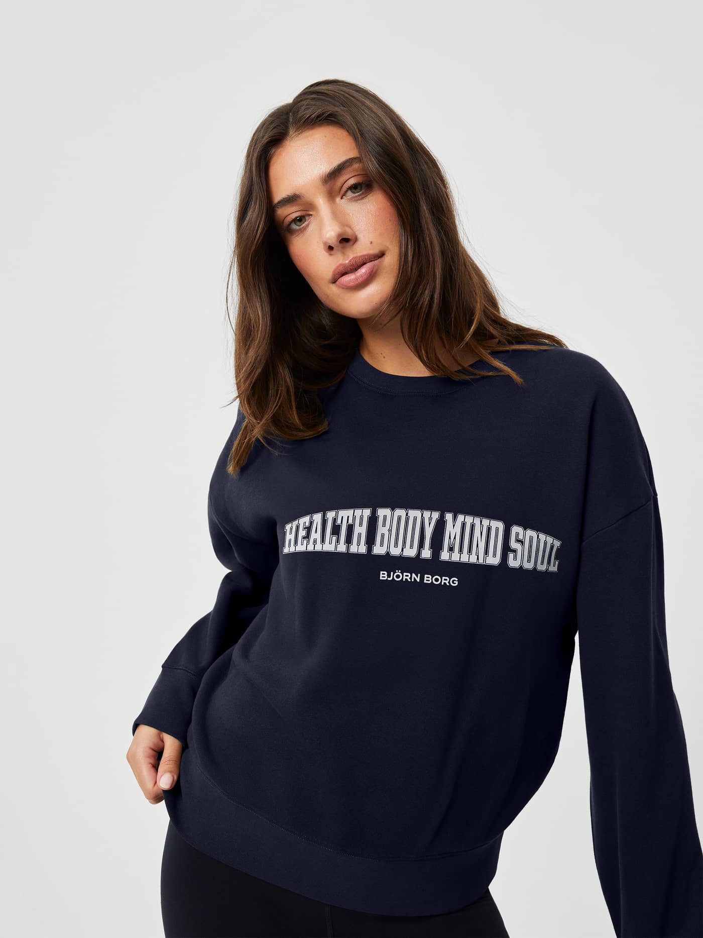 Front view of the navy Björn Borg Ace Boyfriend Crew in soft fleece with a stylish oversized fit and white chest graphic. - Image 1