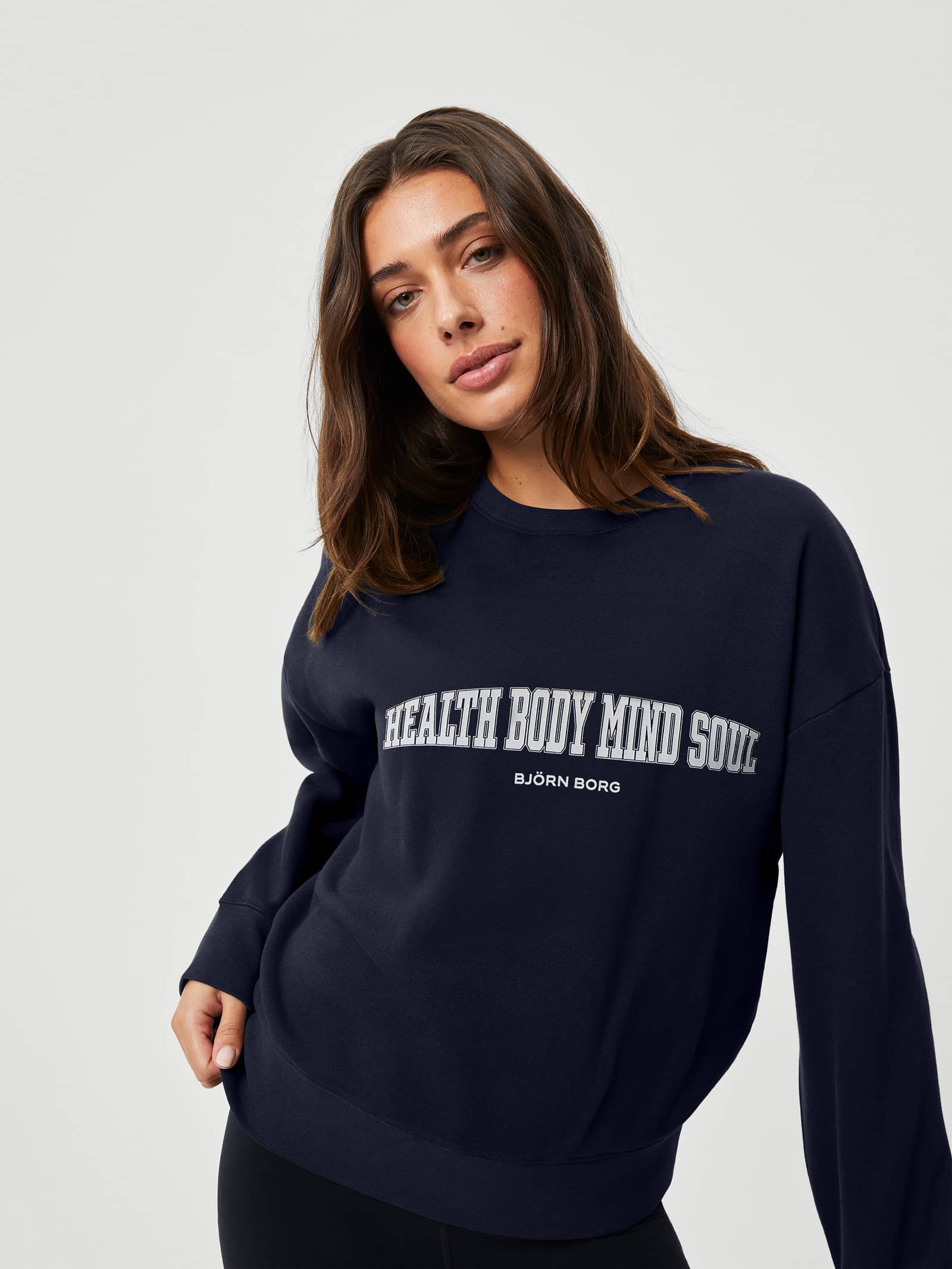 Front view of the navy Björn Borg Ace Boyfriend Crew in soft fleece with a stylish oversized fit and white chest graphic. - Image 1