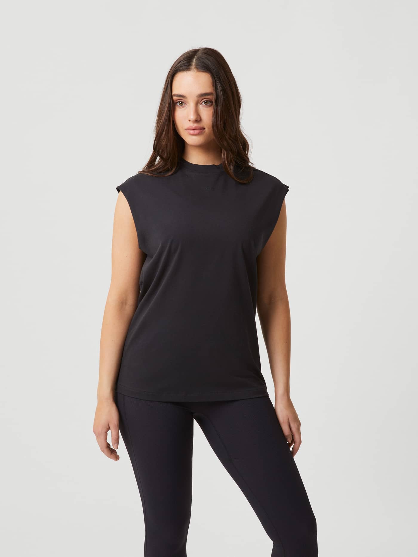 Front view of a model wearing the Björn Borg Studio Loose Fit Tank in Black Beauty (Black), a soft cotton training top. - Image 1