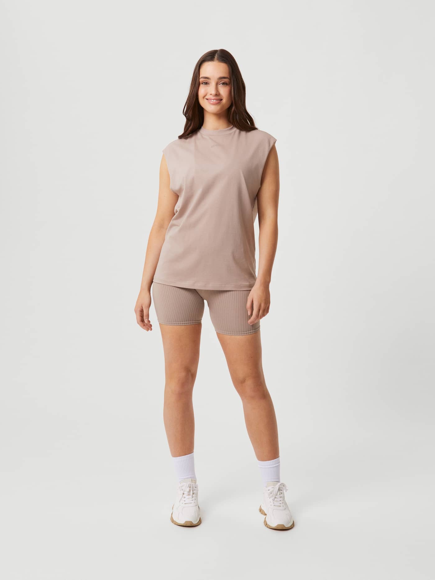 Studio Loose Fit Tank i Etherea (Beige) til trening, vist forfra i full lengde på en modell med løs passform. - Image 3