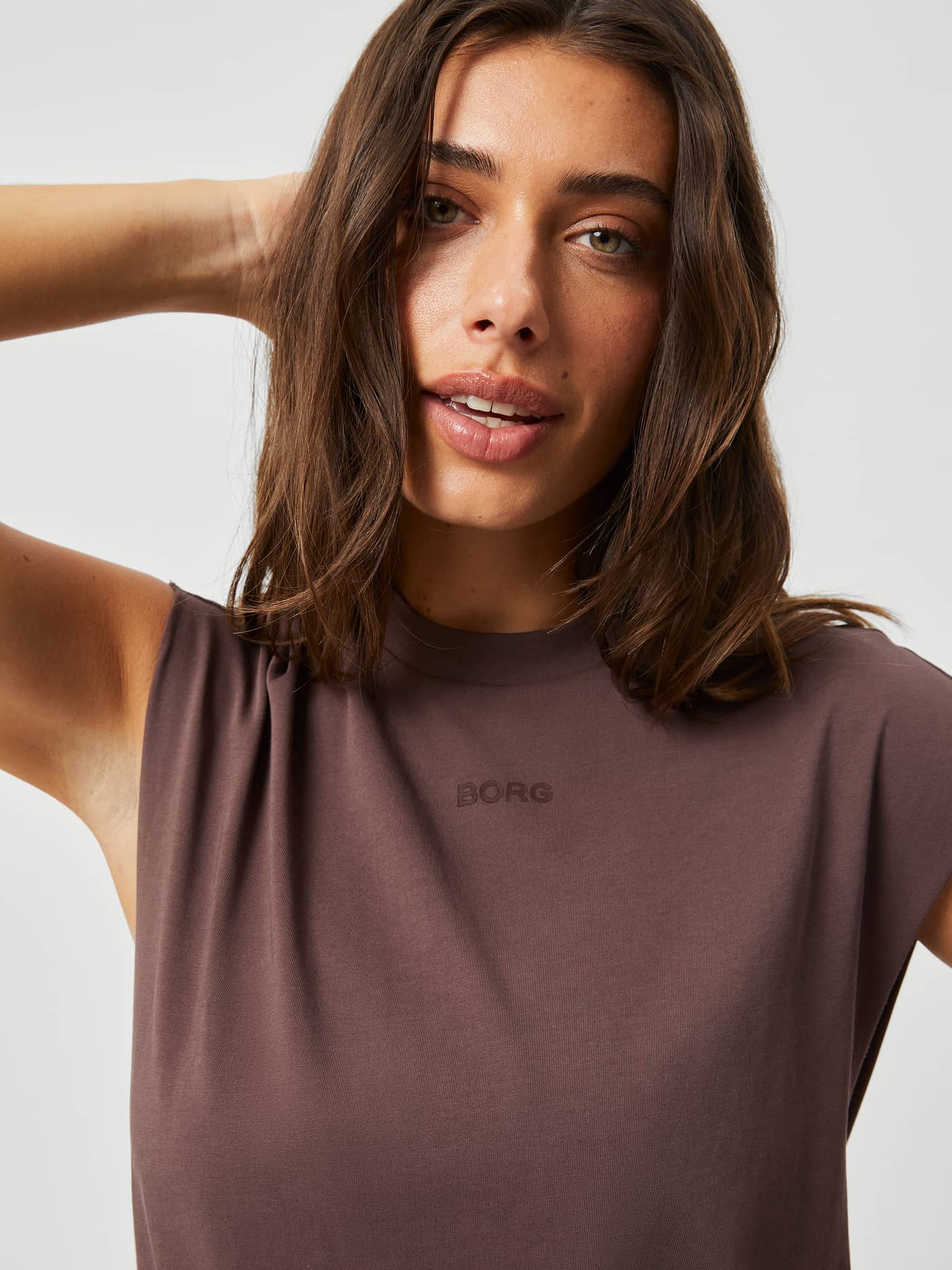 Close-up of the Björn Borg Studio Loose Fit Tank in French Toast (Brown) with a tonal logo for stylish training. - Image 4
