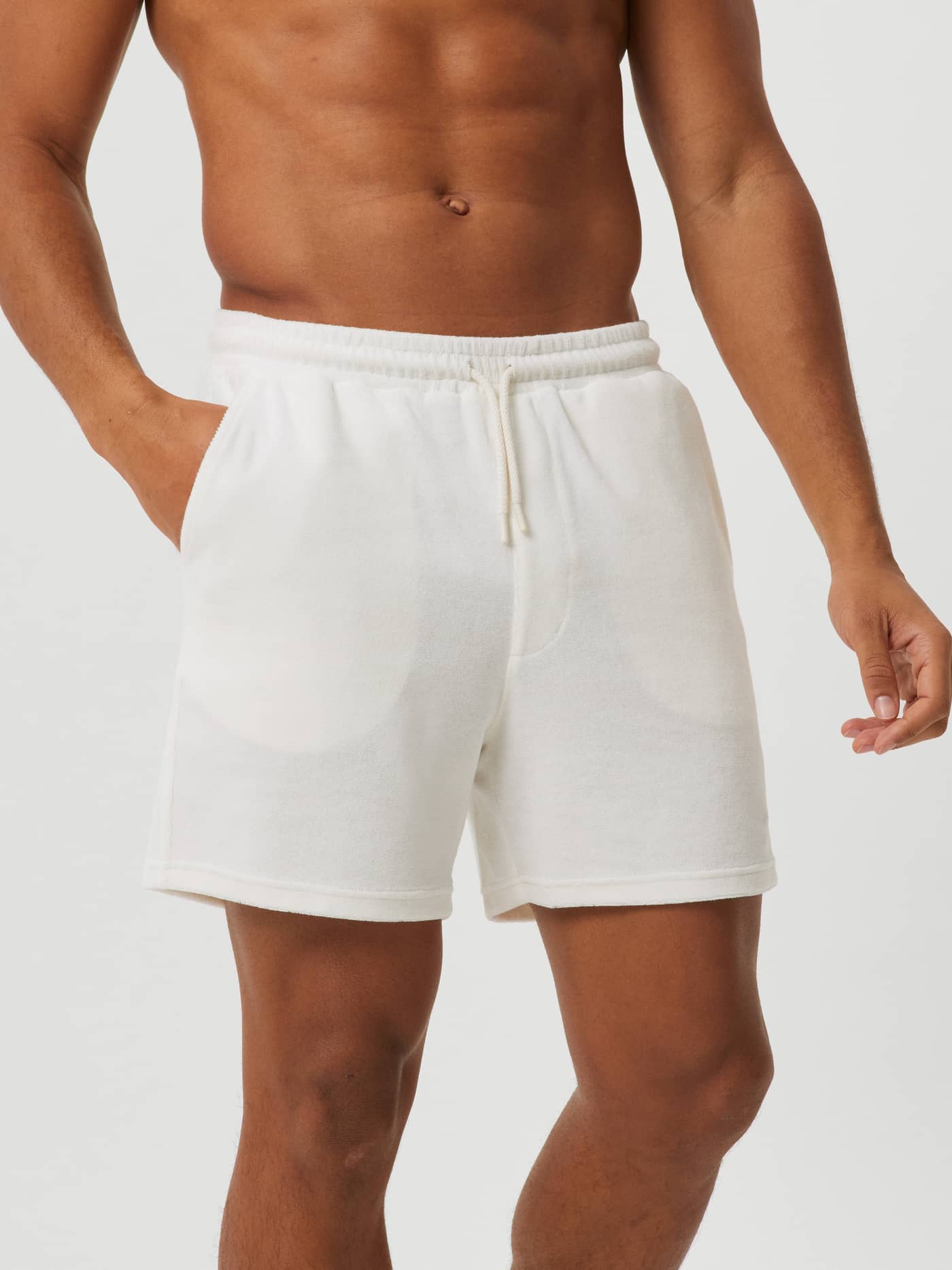 Front view of a man wearing the Björn Borg Toweling Pool Shorts in Egret (White), made from soft toweling fabric. - Image 2
