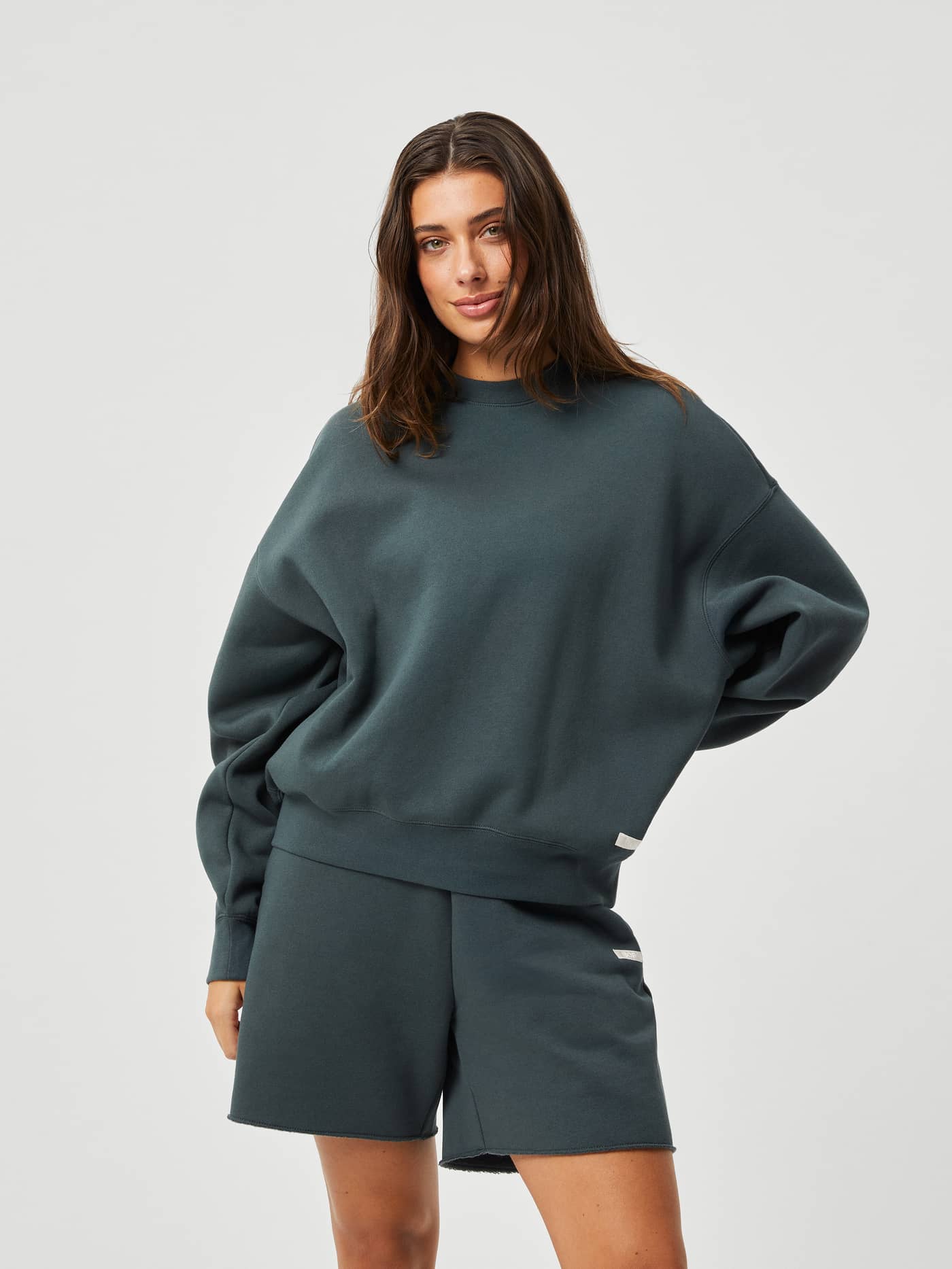 Front view of a model wearing the Björn Borg Studio Oversized Crew in Urban Chic (Green) with a stylish, relaxed fit. - Image 1
