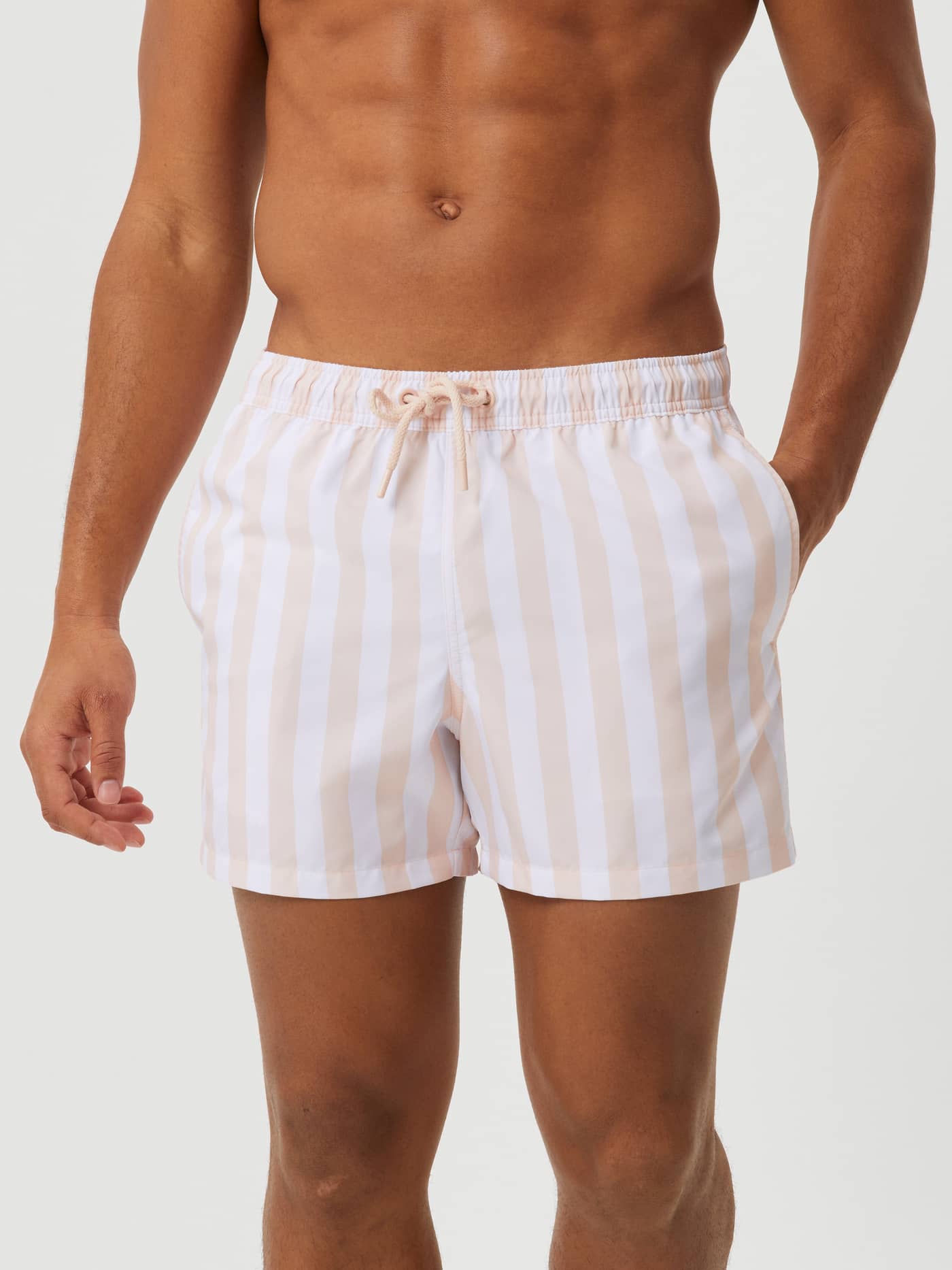 Borg Print Swim Shorts in Sunny Stripe 1 (Roze) op een model in vooraanzicht, gemaakt van sneldrogende gestreepte stof. - Image 1