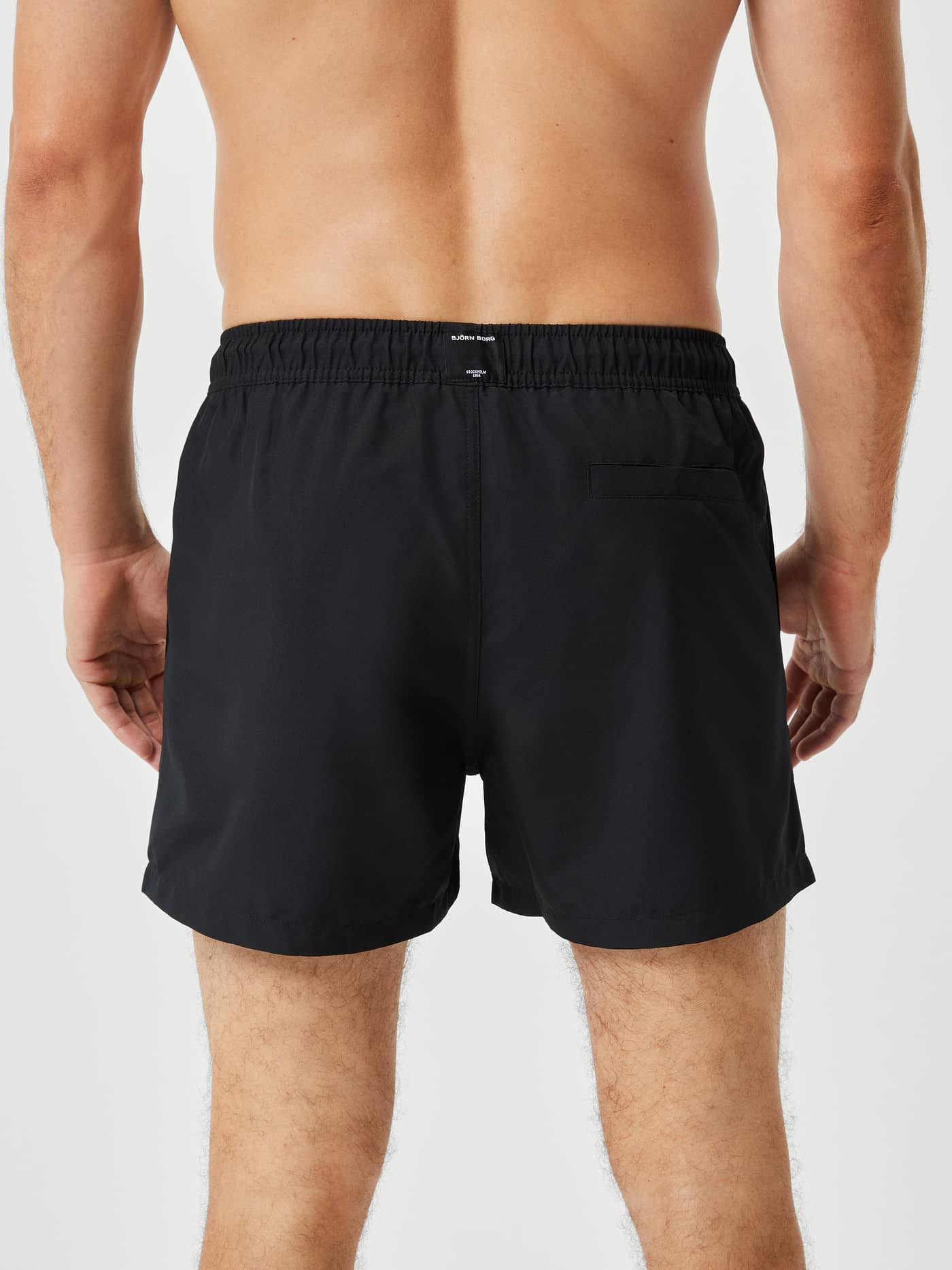 Borg Solid Swim Shorts i Black Beauty (Sort) set bagfra på en mand med en funktionel baglomme. - Image 3