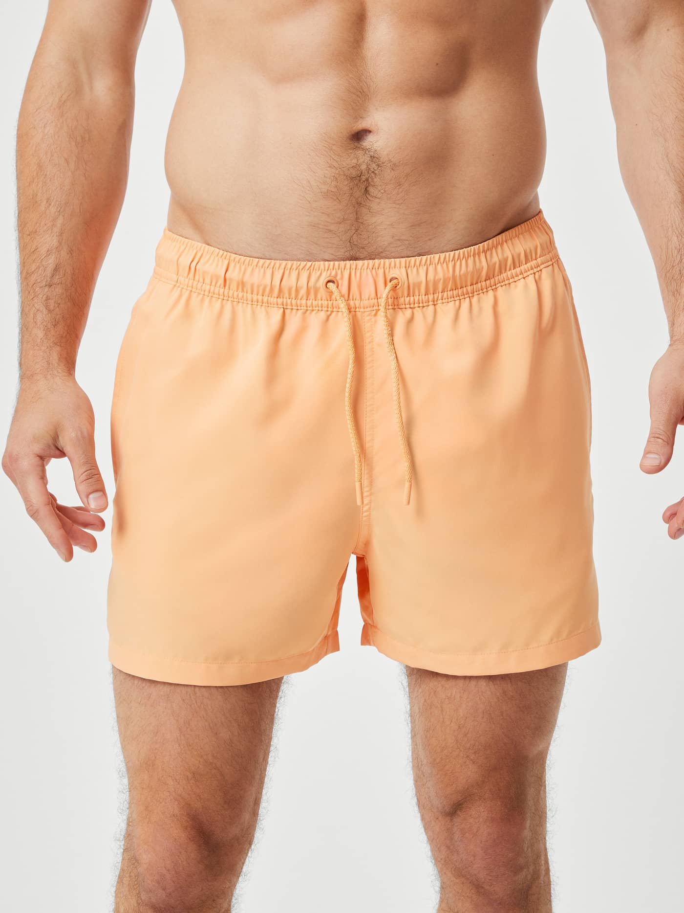 Front view of a model wearing Borg Solid Swim Shorts in Orange Chiffon (Orange), featuring an adjustable drawstring waist. - Image 2