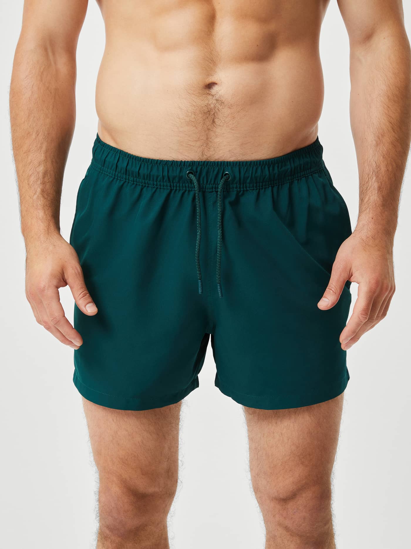 Front view of the Borg Solid Swim Shorts in Ponderosa Pine (Green) made with recycled polyester featuring a drawstring. - Image 2