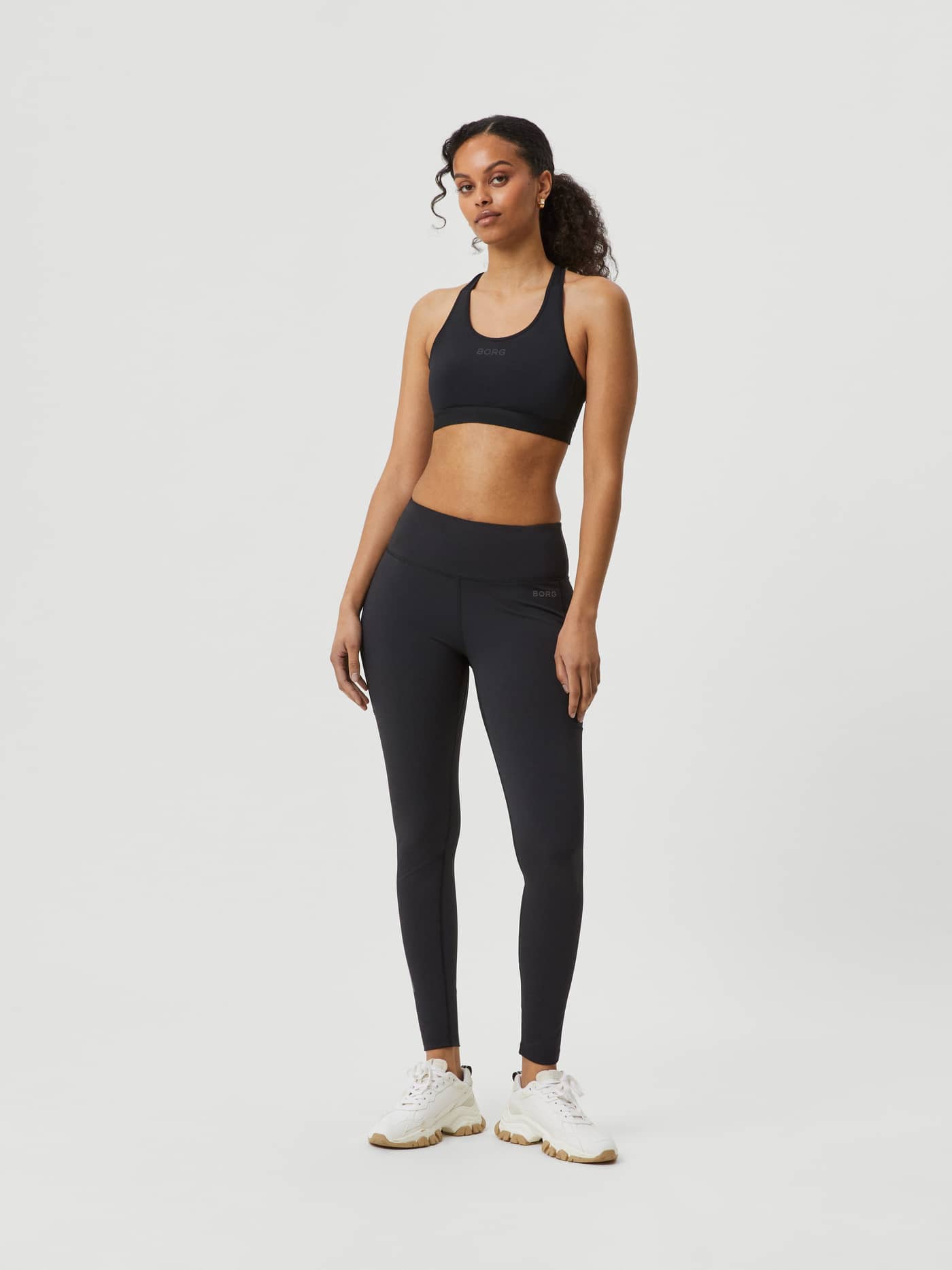 Full-body front view of a model wearing slim-fit performance Björn Borg Running Tights in Black Beauty (Black). - Image 1