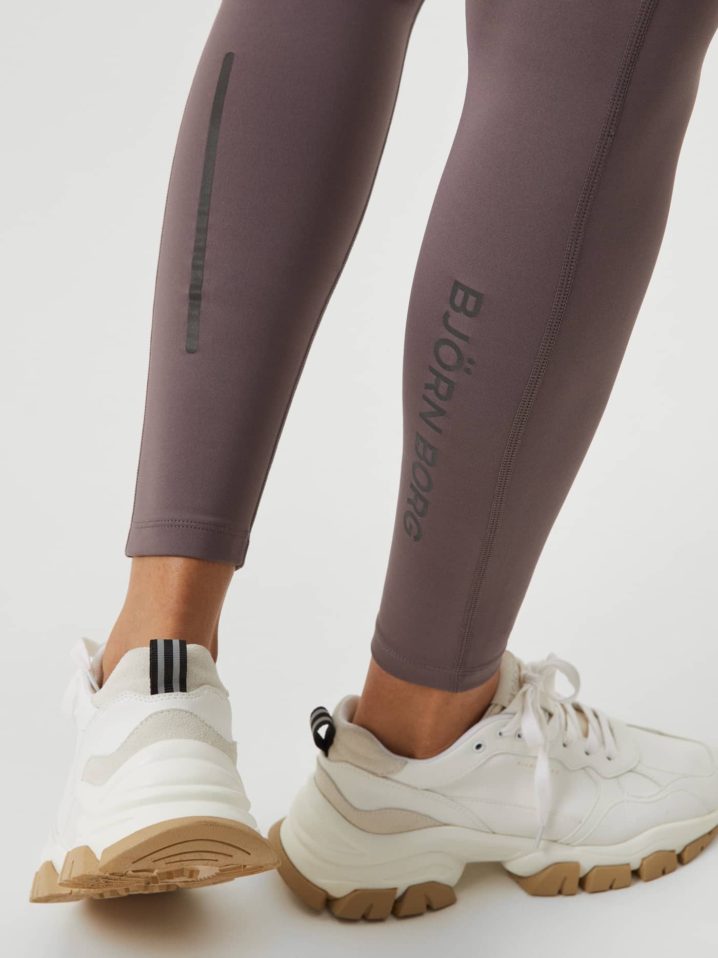Borg Running Tights i Sparrow (Brun) med vertikal refleksstripe og mørk logo på leggen for synlighet under løping. - Image 7