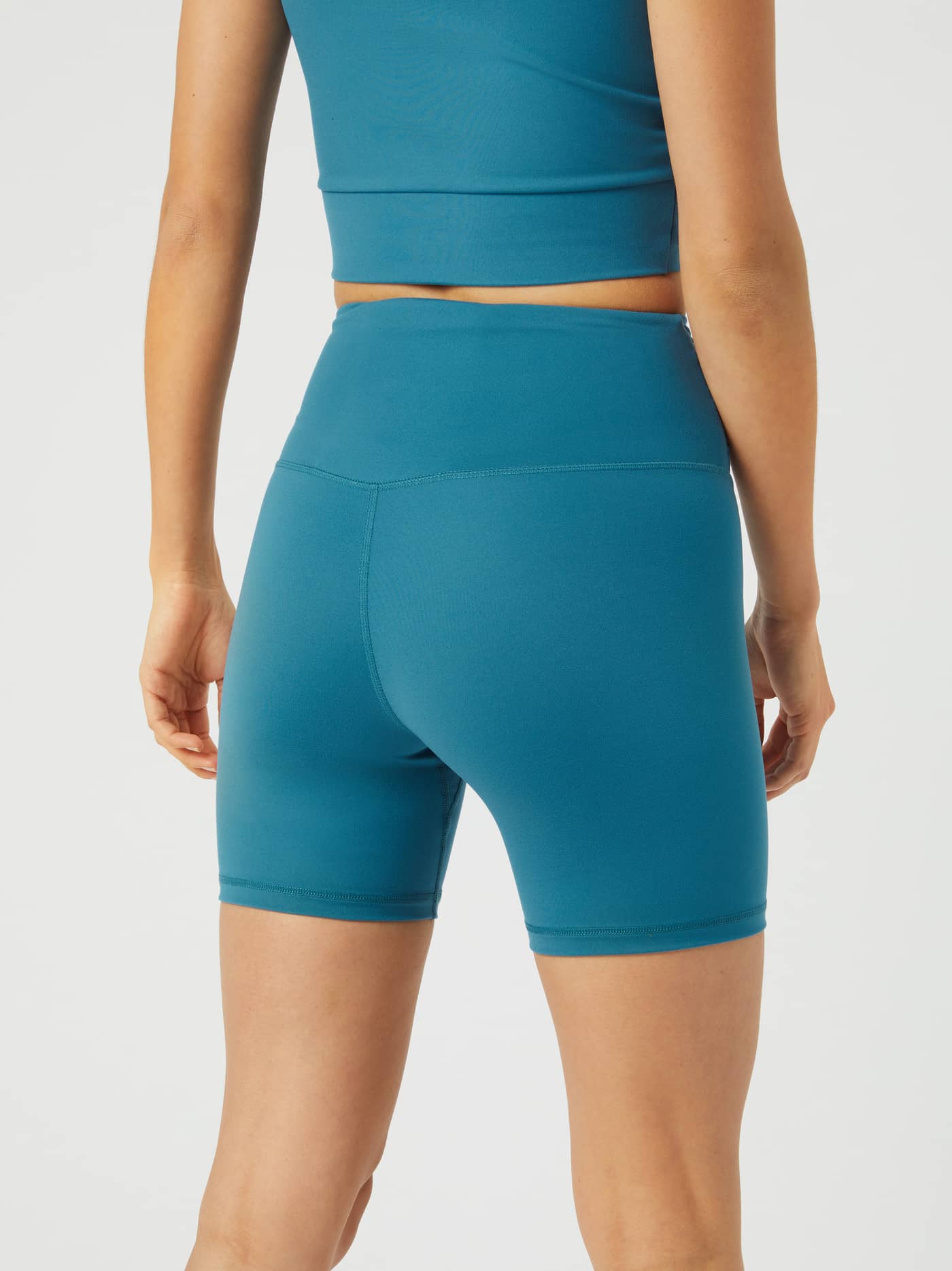 Back view of a model in Mallard Blue (Blue) Björn Borg Studio Cross Shorts, featuring a high-waist fit for training. - Image 3