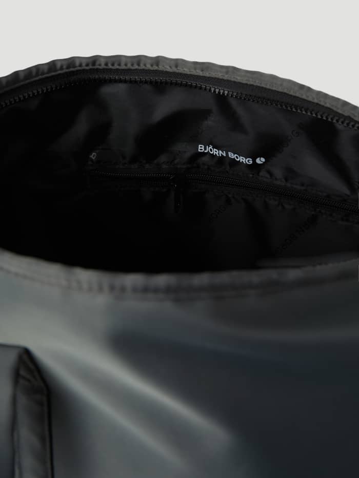 Interior of the Sthlm Leisure Shopper in Olive Night (Green) with a zippered pocket and white logo on tonal polyester lining. - Image 4