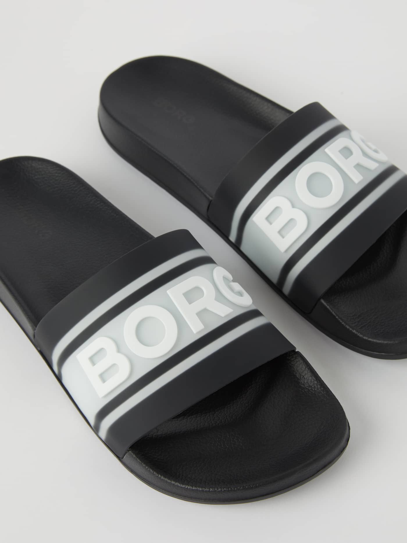 Angled view of the black Knox Men's Molded Slides in flexible TPU with a white BORG logo for signature functional style. - Image 2