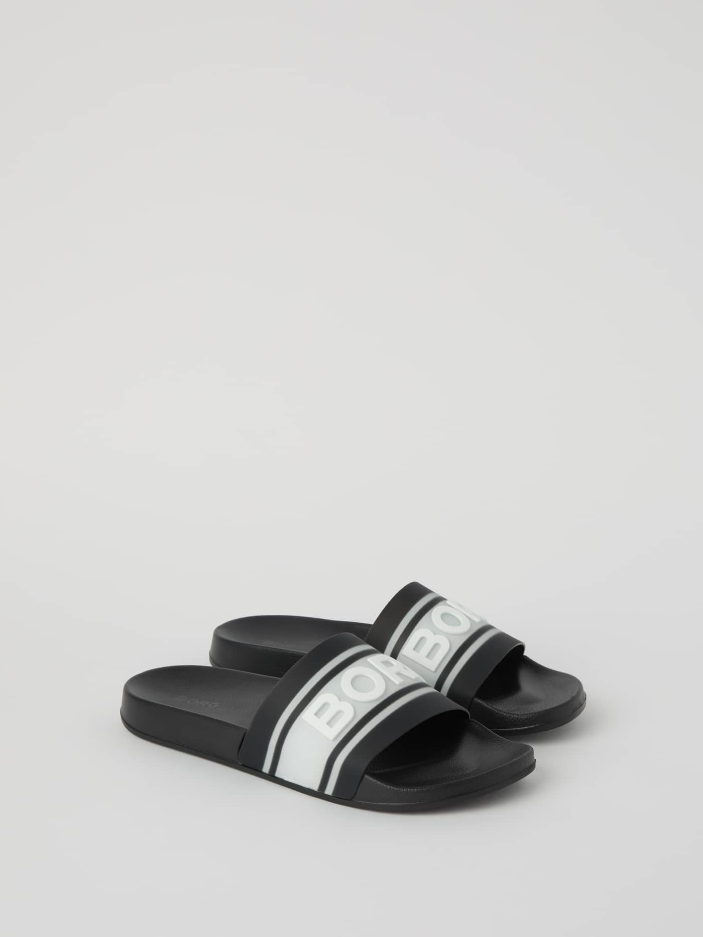 Side view of the stylish black Björn Borg Knox Men's Molded Slides featuring a white logo and functional TPU rubber. - Image 1