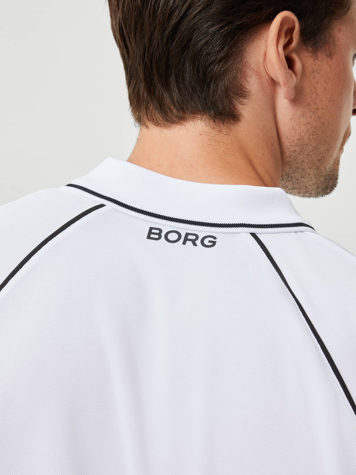 Back view of the Björn Borg Ace Racquet Polo in Brilliant White (White) with a black logo and contrast piping for tennis. - Image 4