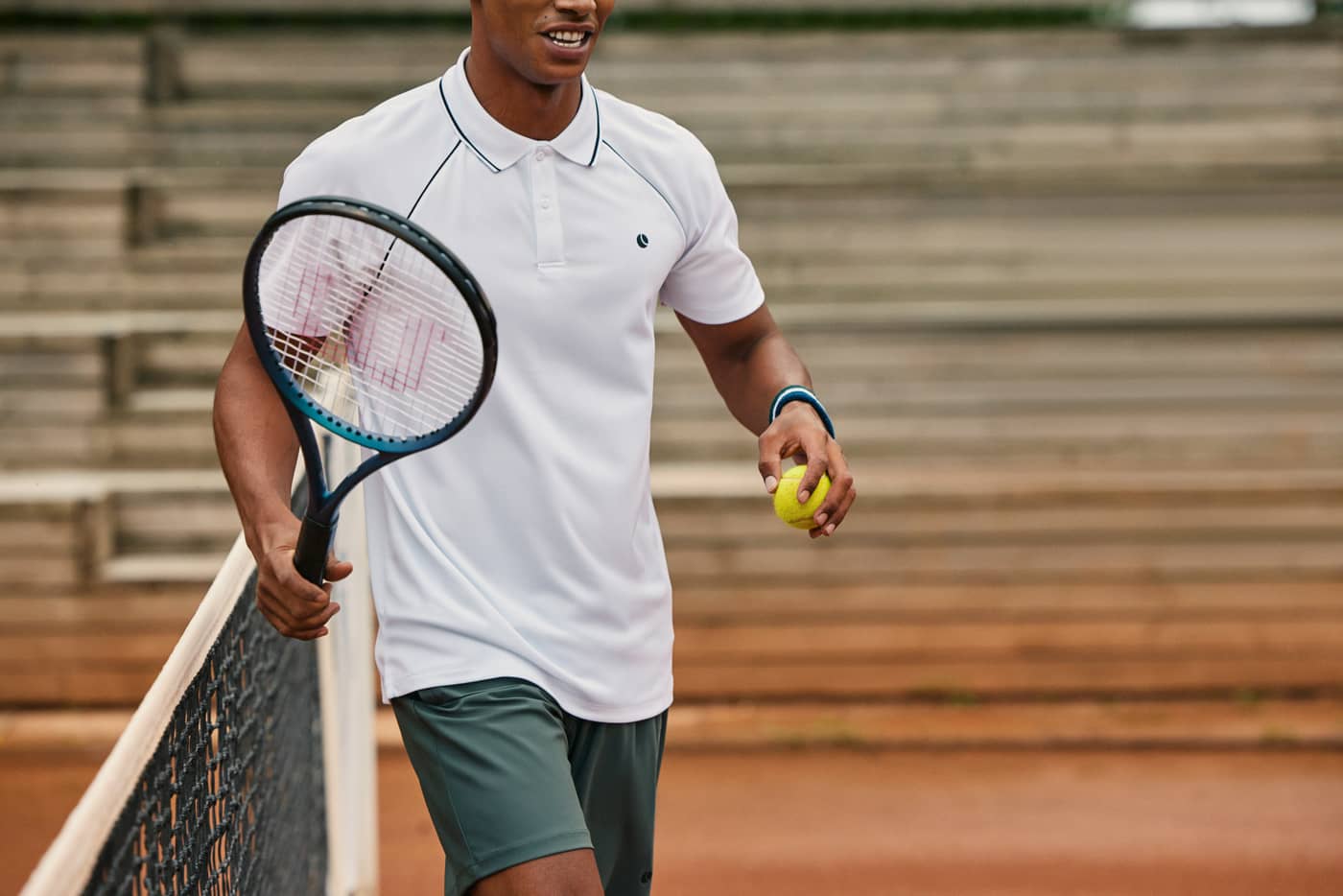 Björn Borg Ace Racquet Polo in Brilliant White (White) on a man on a tennis court, with stylish, functional raglan sleeves. - Image 6