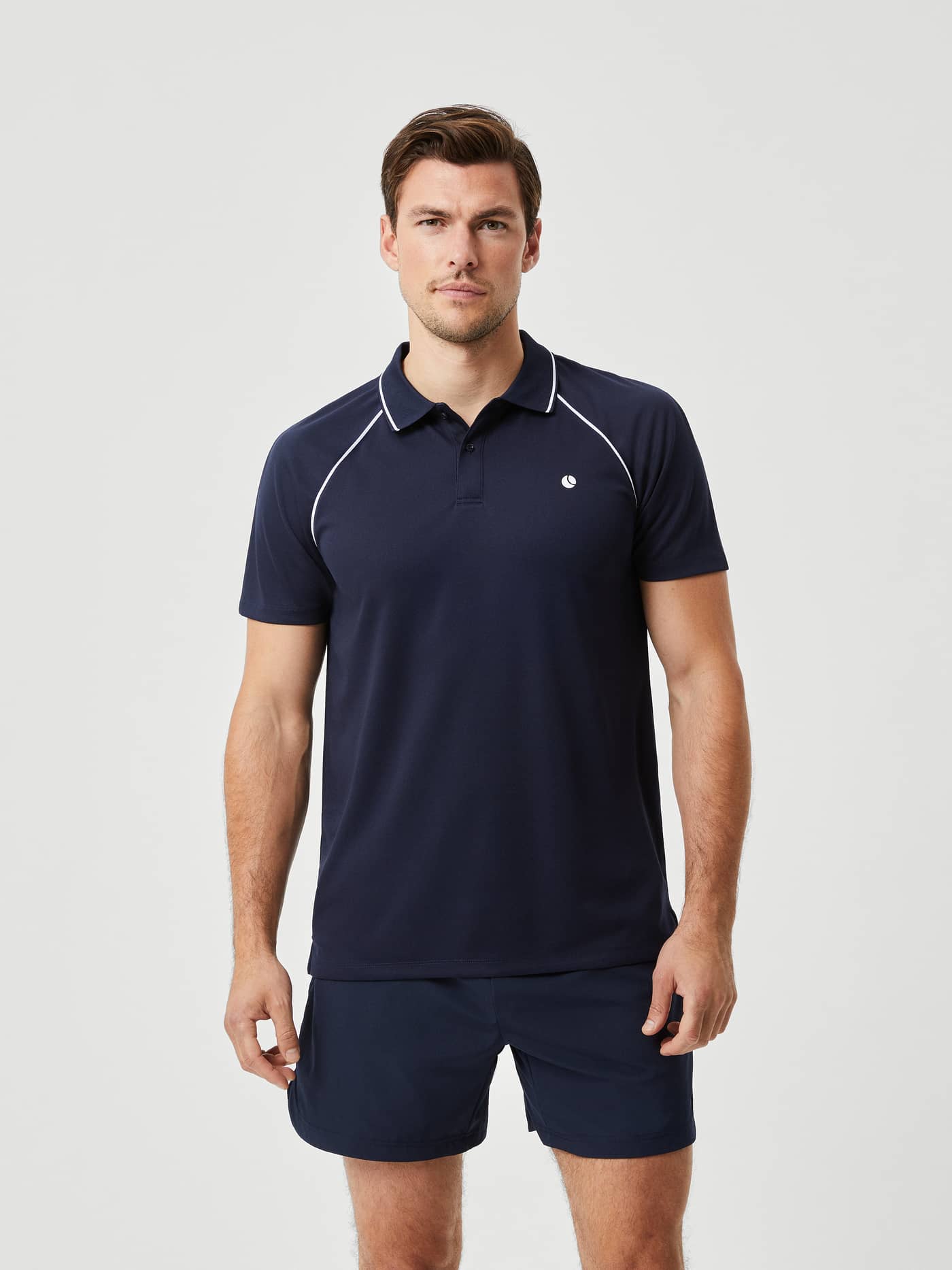 Front view of a man in the Björn Borg Ace Racquet Polo in Night sky (Blue), a tennis shirt built for style and performance. - Image 1