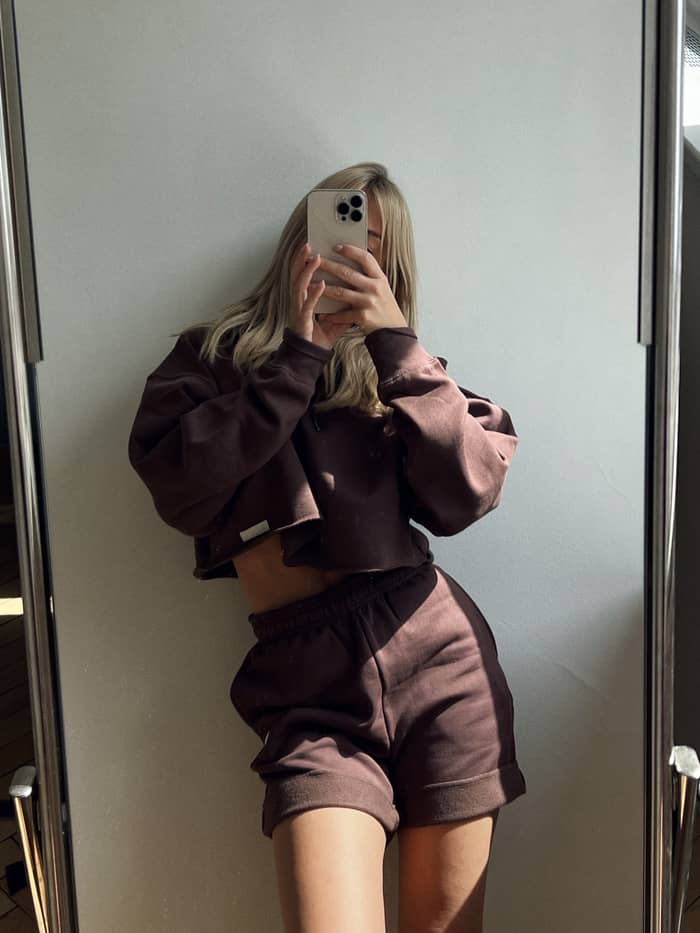 High-waisted Studio Oversized Shorts in French Toast (Brown) worn by a woman in a mirror selfie. - Image 4