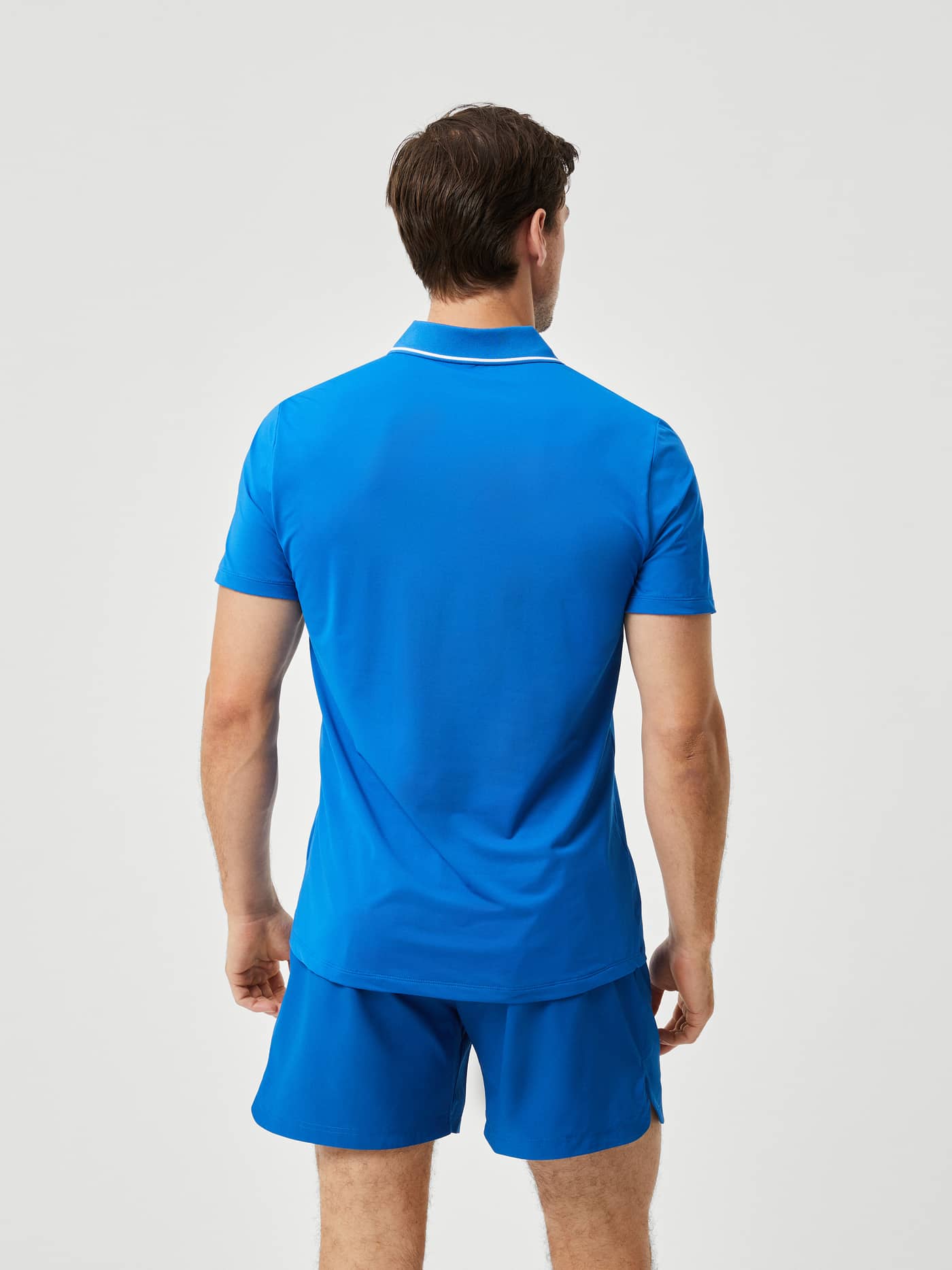 Back view of a man wearing the Björn Borg Ace Light Polo in Classic Blue (Blue), a performance-driven tennis shirt. - Image 3