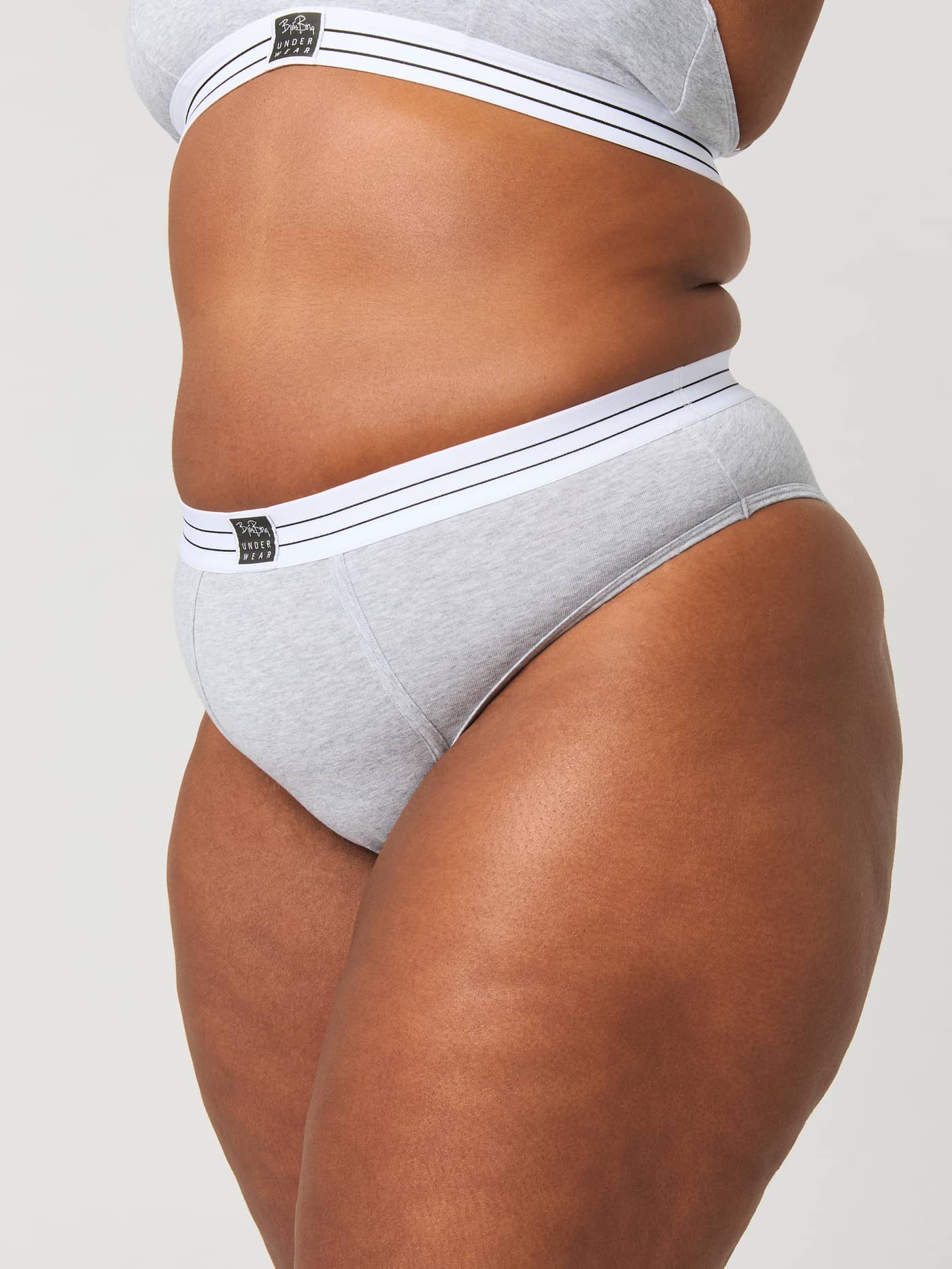 Side view of a model wearing the grey Core Original High Waist Brief 2-pack with a flattering high-waisted fit. - Image 10