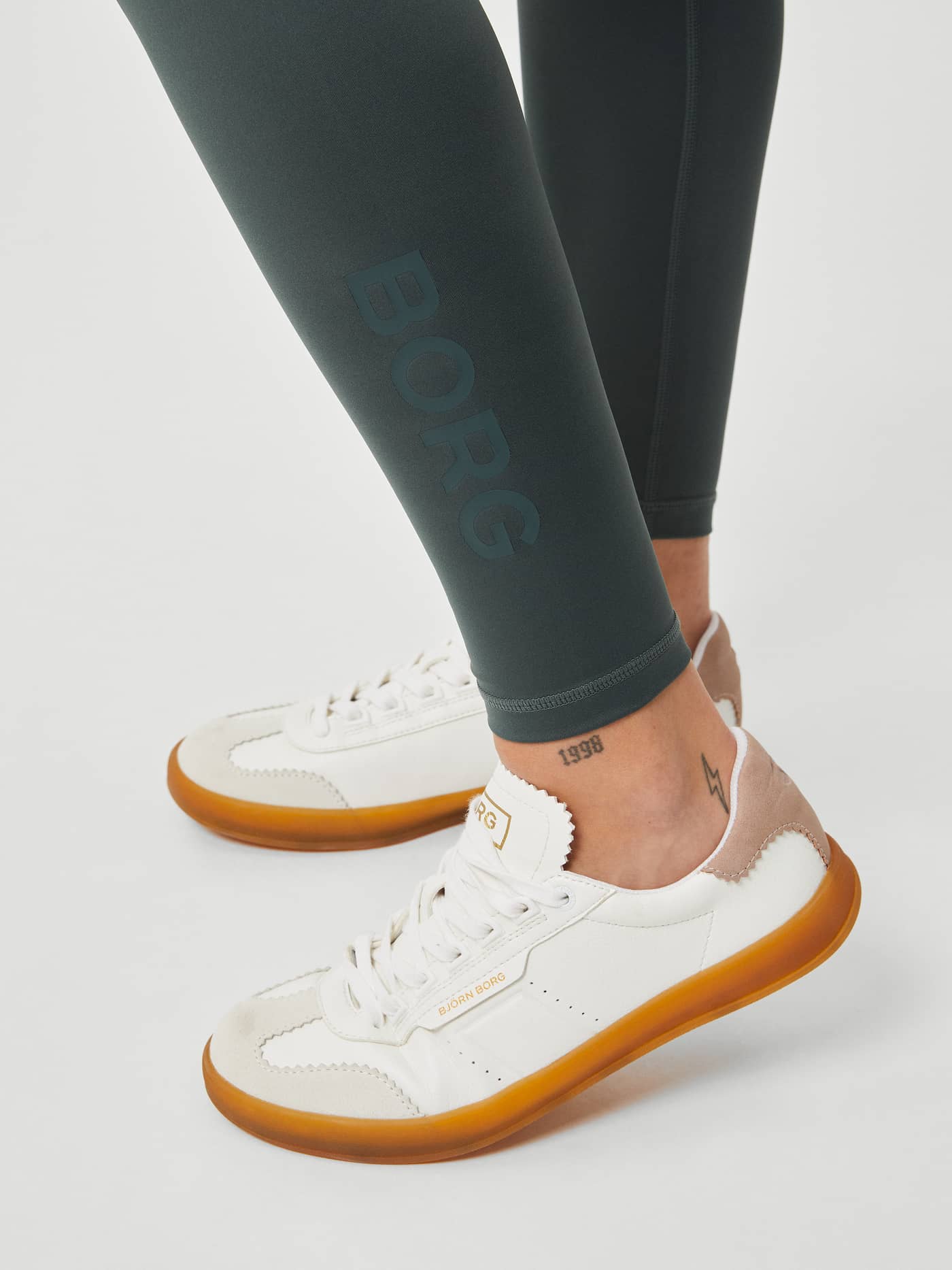 Borg Logo Tights in Urban Chic (Green) for women's training feature a tonal leg logo and are paired with white sneakers. - Image 5