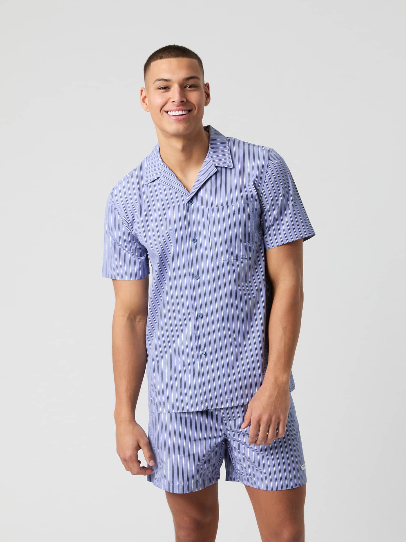 Front view of a model in the striped Thomas Mason Shortsleeve Pyjama Shirt in Country Blue (Blue) made from Italian cotton. - Image 1