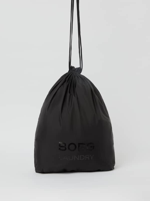 Front view of the lightweight Borg Travel Laundry Bag in Black Beauty (Black) with a drawstring and tonal logo.