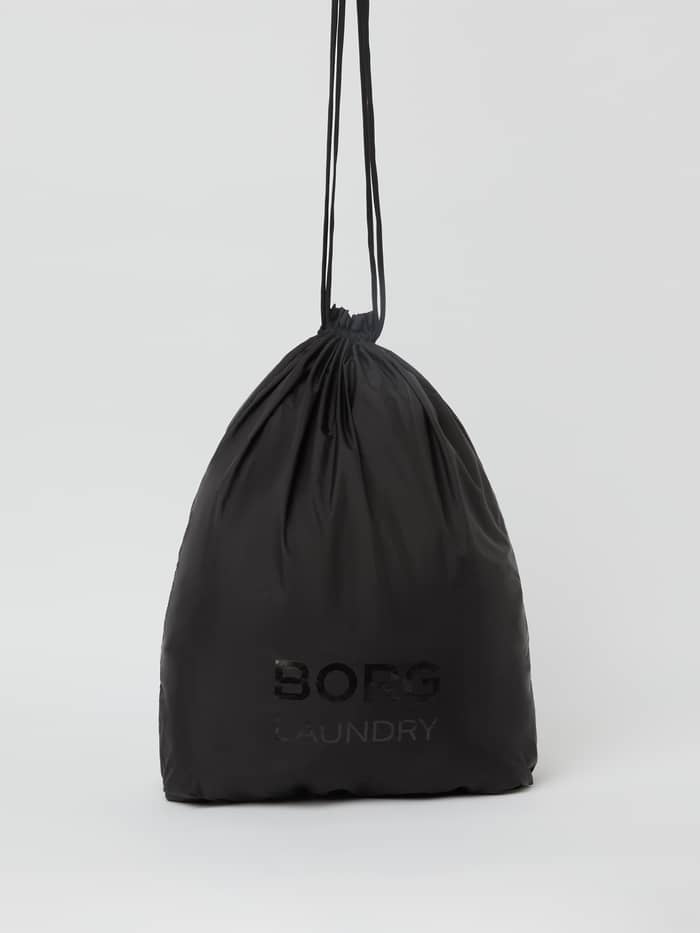 Front view of the lightweight Borg Travel Laundry Bag in Black Beauty (Black) with a drawstring and tonal logo.