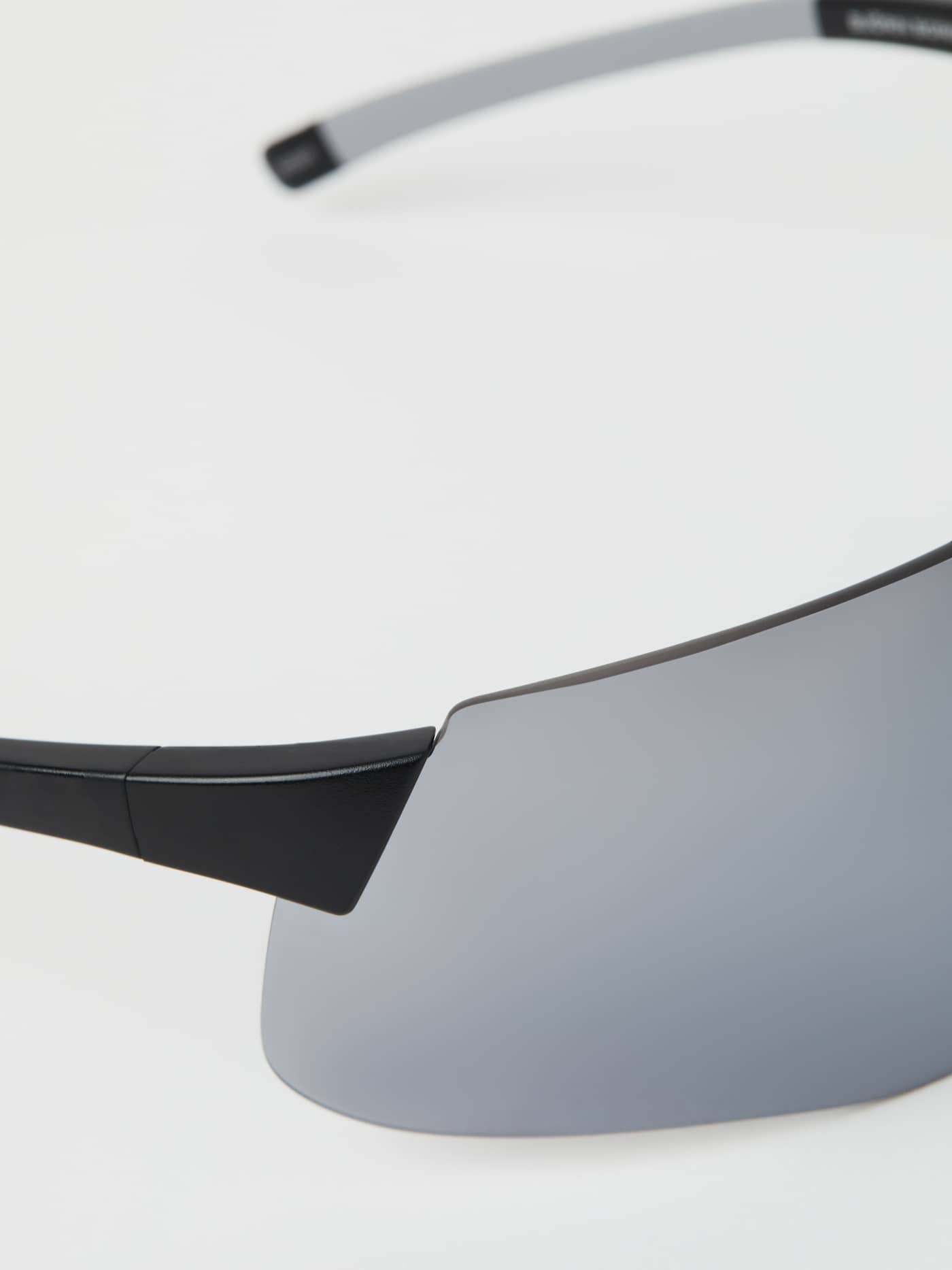 Detailed close-up of the Running Sunglasses in Black, showcasing the lightweight shield lens for performance running. - Image 6